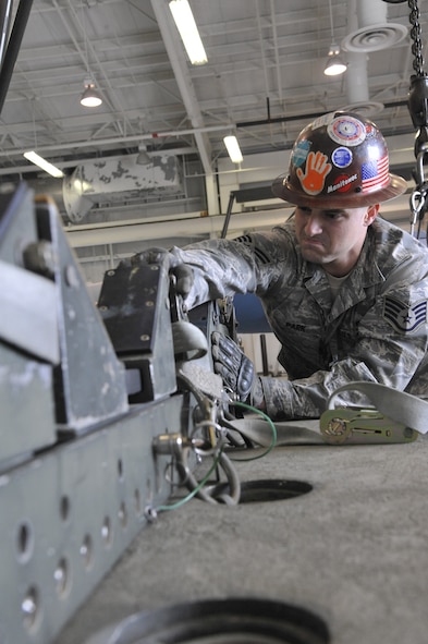 U.S. Air Force Staff Sgt. William Park, 131st Maintenance Squadron Munitions Flight conventional maintenance section crew chief, ensures the MHU-110 trailer is ready for an assembled munitions load at Whiteman Air Force Base, Mo., April 1, 2014. The trailer has a rated weight capacity of 15,000 pounds.  (U.S. Air Force photo by Airman 1st Class Keenan Berry/Released)