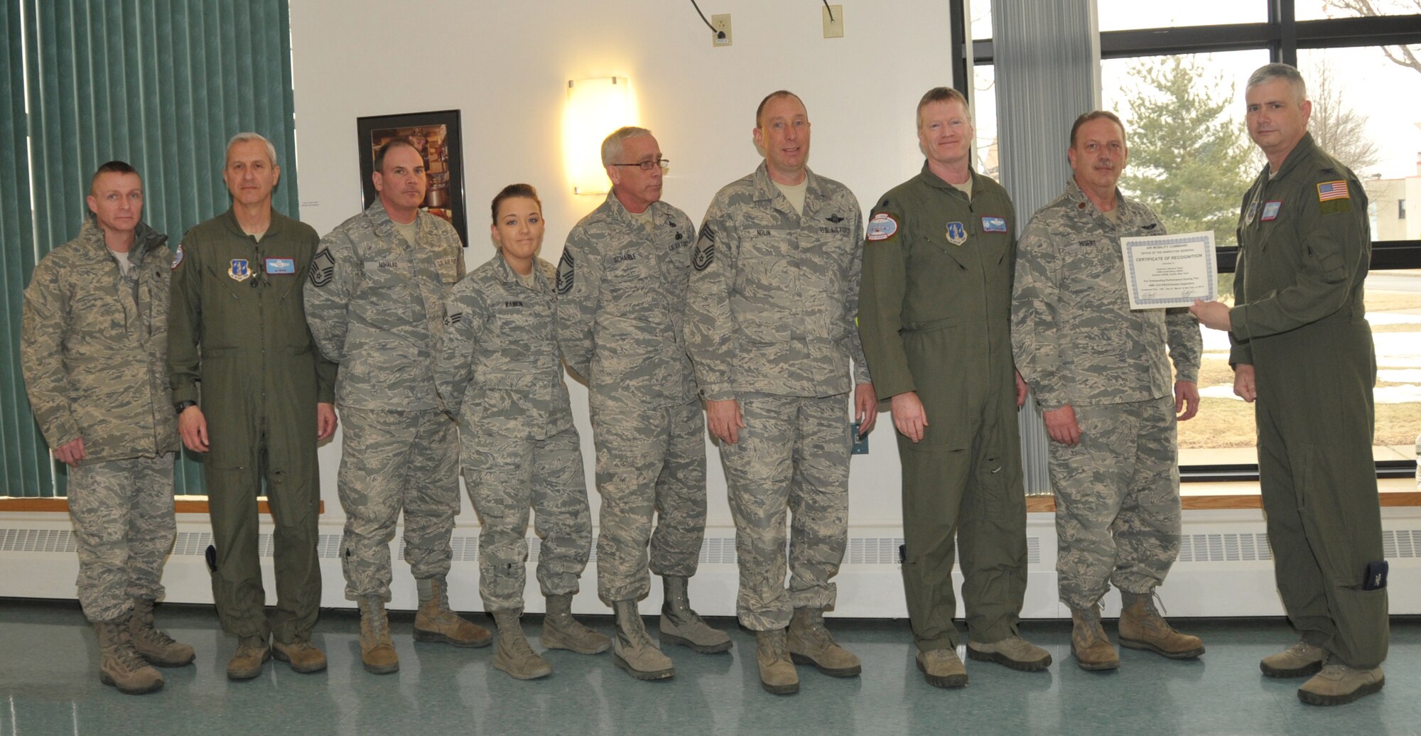 STRATTON AIR NATIONAL GUARD BASE, N.Y. -- Col. Shawn Clouthier (right), 109th Airlift Wing commander, presents the 109th AW Inspector General Team with a certificate of recognition March 25, 2014, from Air Mobility Command for outstanding performance during the 109th AW's recent Unit Effectiveness Inspection. Pictured are (from left) Maj. Ernest Lancto, Lt. Col. Alan Ross, Senior Master Sgt. Greg Mihalko, Senior Airman Brittany Rankin, Chief Master Sgt. Mark Schaible, Chief Master Sgt. William Nolin, Lt. Col. Matthew LeClair and Maj. Glen Hisert. (Air National Guard photo by Master Sgt. William Gizara/Released)