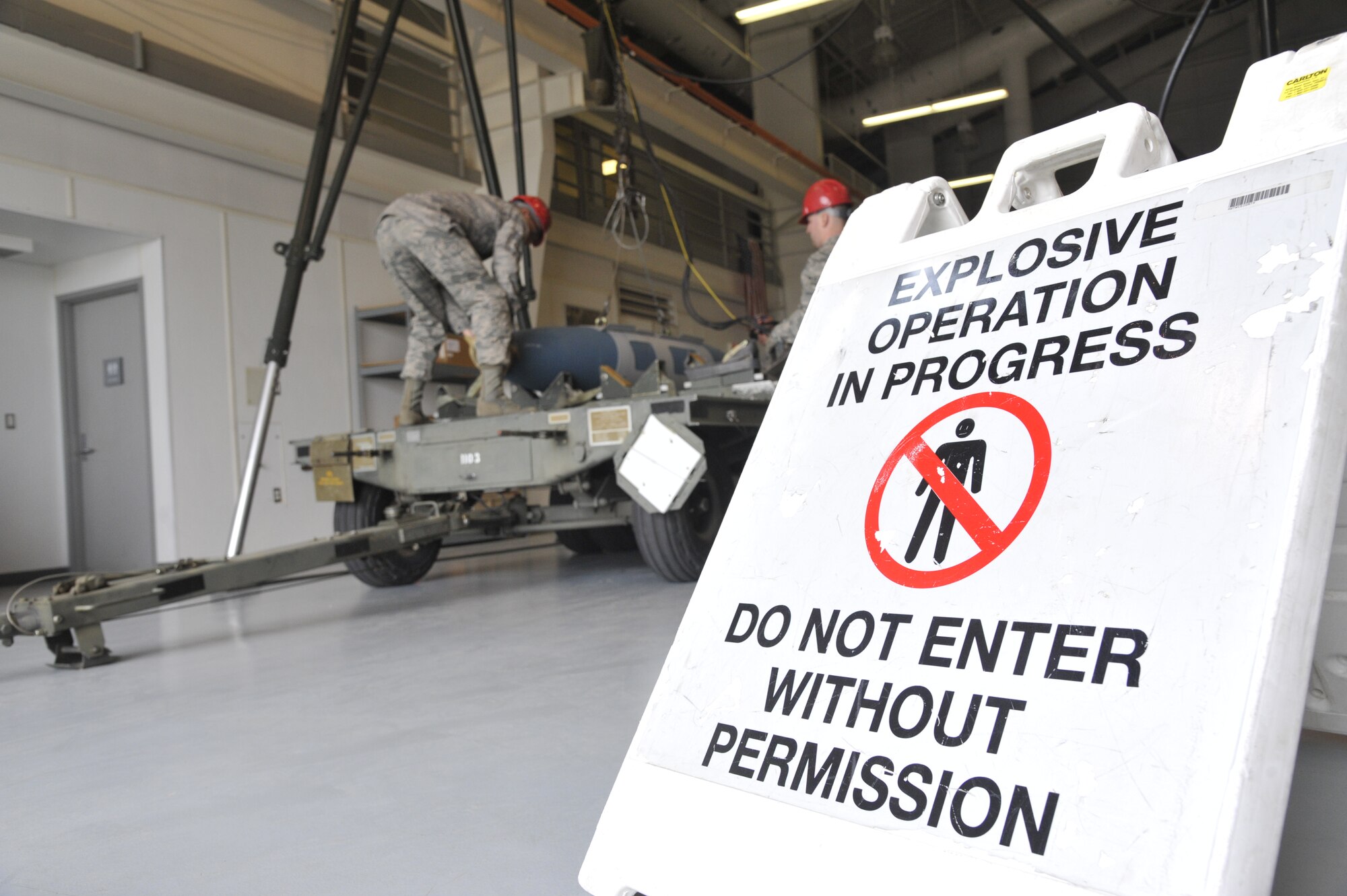 Airmen from the 509th Munitions Squadron conventional maintenance section use a munitions assembly conveyor  to load munitions, using a device called the gantry, onto an MHU-110 trailer at Whiteman Air Force Base, Mo., April 1, 2014. The gantry is a sub-assembly of the MAC. (U.S. Air Force photo by Airman 1st Class Keenan Berry/Released)