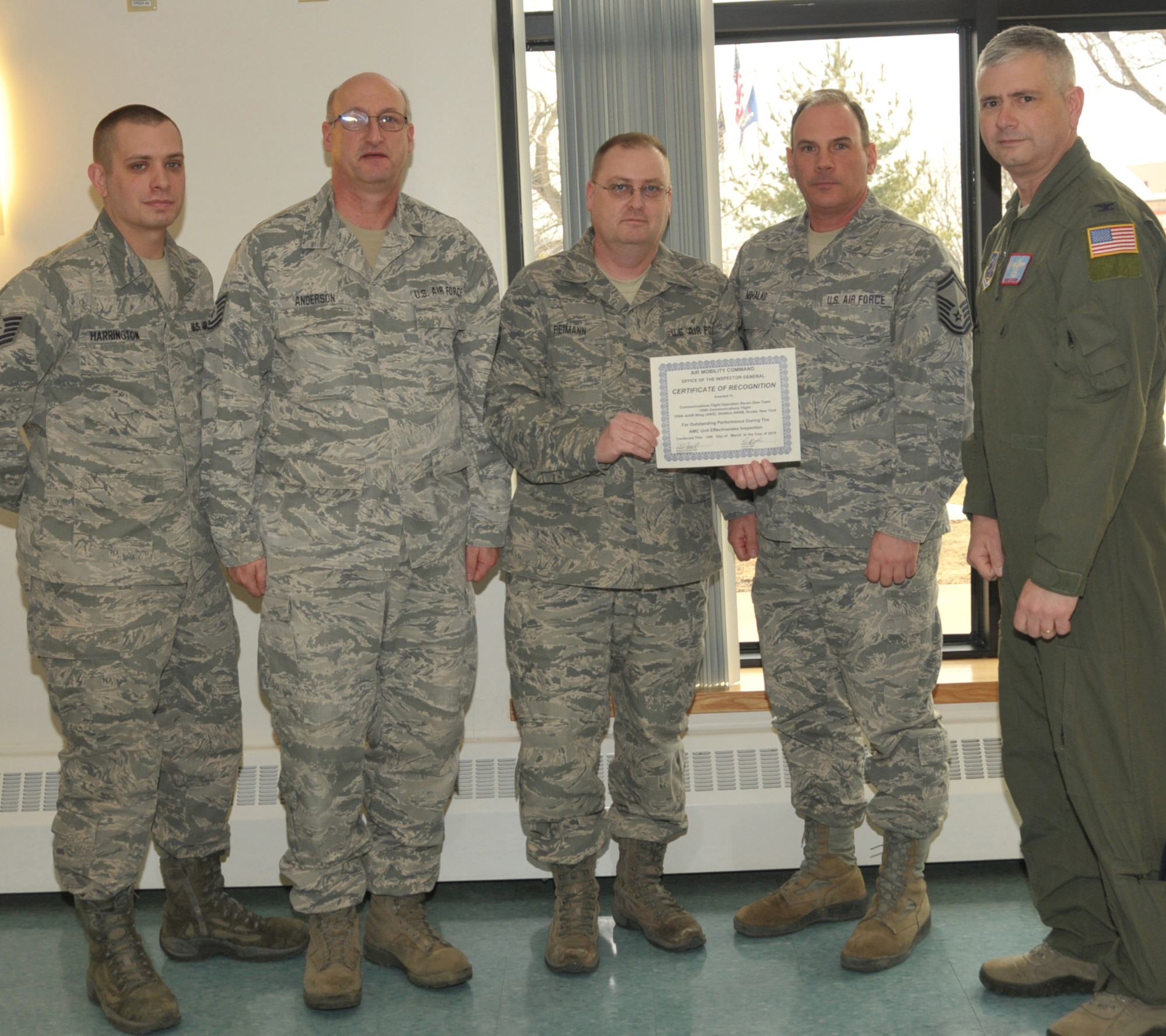 STRATTON AIR NATIONAL GUARD BASE, N.Y. -- Col. Shawn Clouthier (right), 109th Airlift Wing commander, presents (from left) Tech. Sgt. Robert Harrington, Tech. Sgt. Scott Anderson, Master Sgt. Patrick Reimann and Senior Master Sgt. Greg Mihalko with a certificate of recognition March 25, 2014, from Air Mobility Command for outstanding performance during the 109th AW's recent Unit Effectiveness Inspection. The Airmen, of the 109th Communications Flight, received team recognition as part of the Communications Flight Operation Raven Dew Team. Other members of the team not pictured were retired Senior Master Sgt. Jeffrey Lapp, Staff Sgt. Johnny Cope and Senior Airman Daniel Street. (Air National Guard photo by Master Sgt. William Gizara/Released)