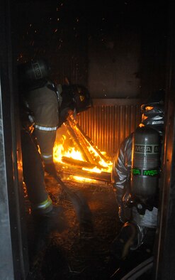 U.S. Air Force Chris Finkes, 509th Civil Engineer Squadron crew chief, left, and Senior Airman Tony Beaudry, 509th CES operator, extinguish a fire during controlled burn training at Whiteman Air Force Base, Mo., March 19, 2014. This training allows firefighters to get a “feel” for the fire, as well as extinguishing it. (U.S. Air Force photo by Airman 1st Class Keenan Berry/Released)