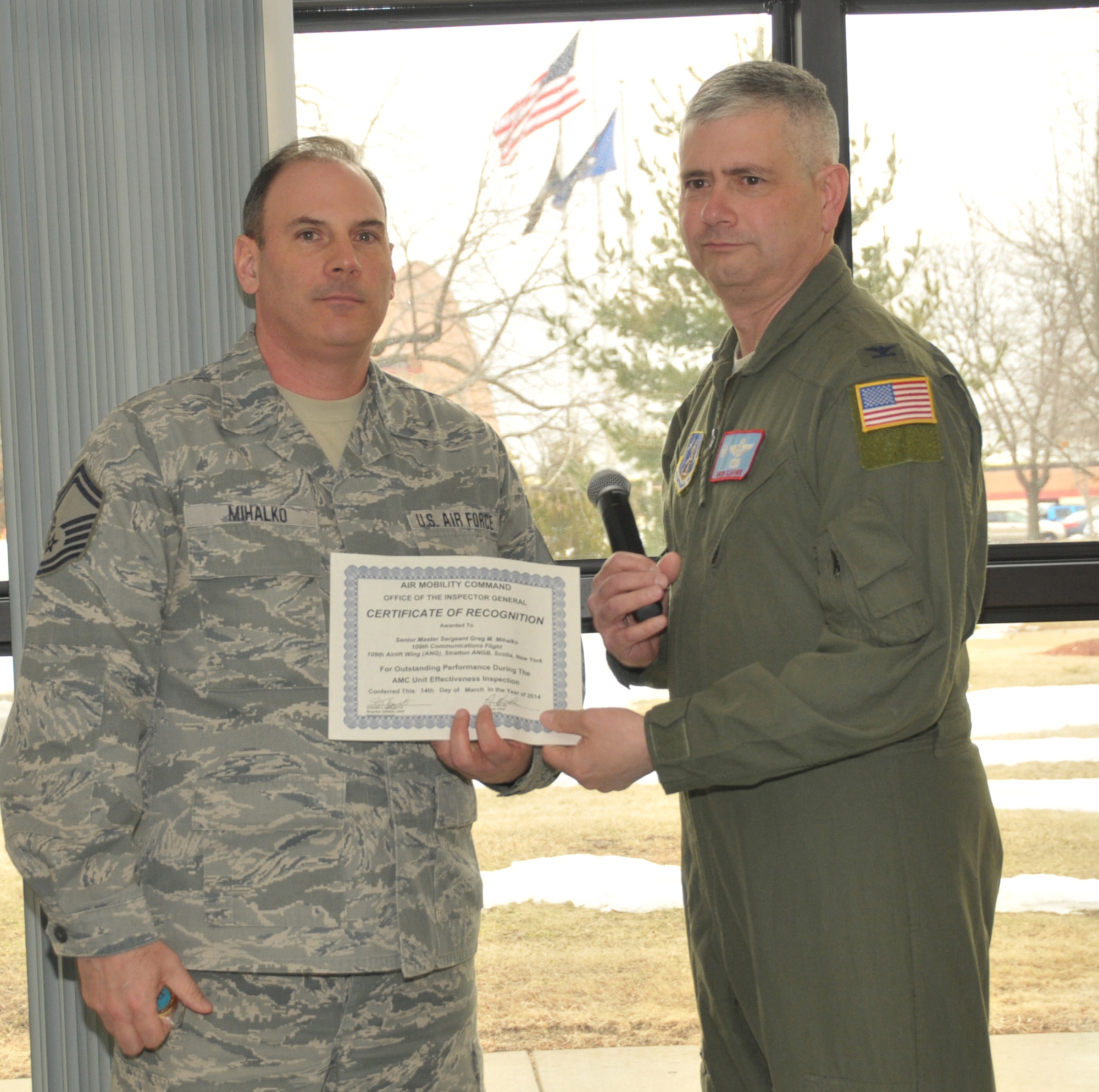 STRATTON AIR NATIONAL GUARD BASE -- Col. Shawn Clouthier (right), 109th Airlift Wing commander, presents Senior Master Sgt. Greg Mihalko with a certificate of recognition March 25, 2014, from Air Mobility Command for outstanding performance during the 109th Airlift Wing's recent Unit Effectiveness Inspection. Mihalko was the sole Inspector General coin recipient for the inspection. He is assigned to the 109th Communications Flight and is also a member of the Wing IG Team. (Air National Guard photo by Master Sgt. William Gizara/Released)