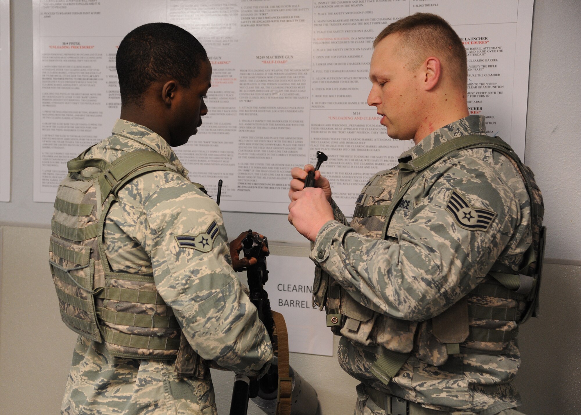 Airman 1st Class Danallen Lee, 341st Security Forces Squadron member (left), and Staff Sgt. Justin Lassiter, 341st Missile Security Forces Squadron area supervisor, go through clearing procedures for an M-4 rifle March 25. Lee arrived at Malmstrom on Jan. 9 and was told he would hold a security position working at Malmstrom’s weapons storage area – a job that requires endless responsibility and constant vigilance.  (U.S. Air Force photo/Senior Airman Cortney Paxton)