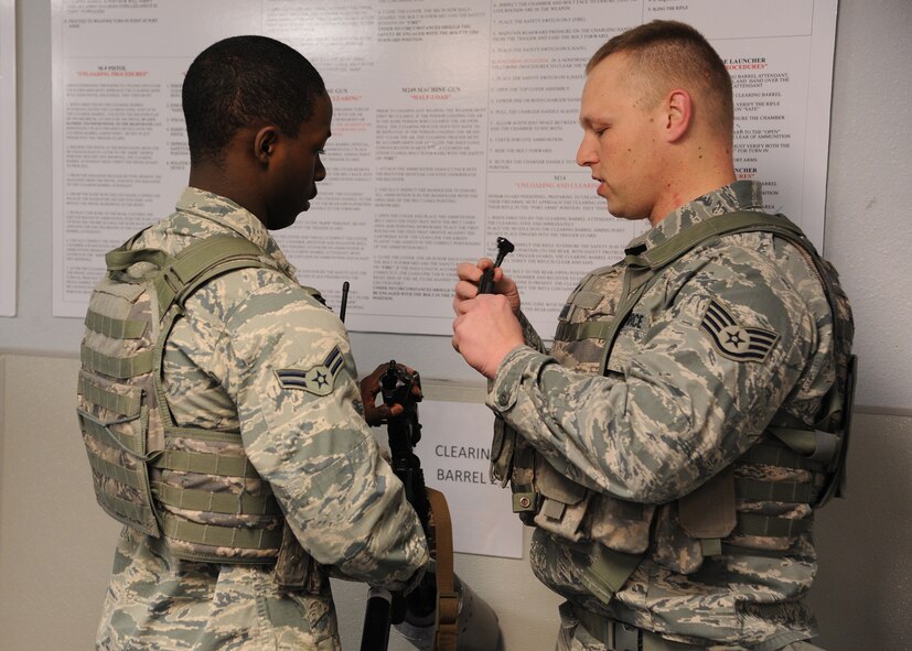 Airman 1st Class Danallen Lee, 341st Security Forces Squadron member (left), and Staff Sgt. Justin Lassiter, 341st Missile Security Forces Squadron area supervisor, go through clearing procedures for an M-4 rifle March 25. Lee arrived at Malmstrom on Jan. 9 and was told he would hold a security position working at Malmstrom’s weapons storage area – a job that requires endless responsibility and constant vigilance.  (U.S. Air Force photo/Senior Airman Cortney Paxton)