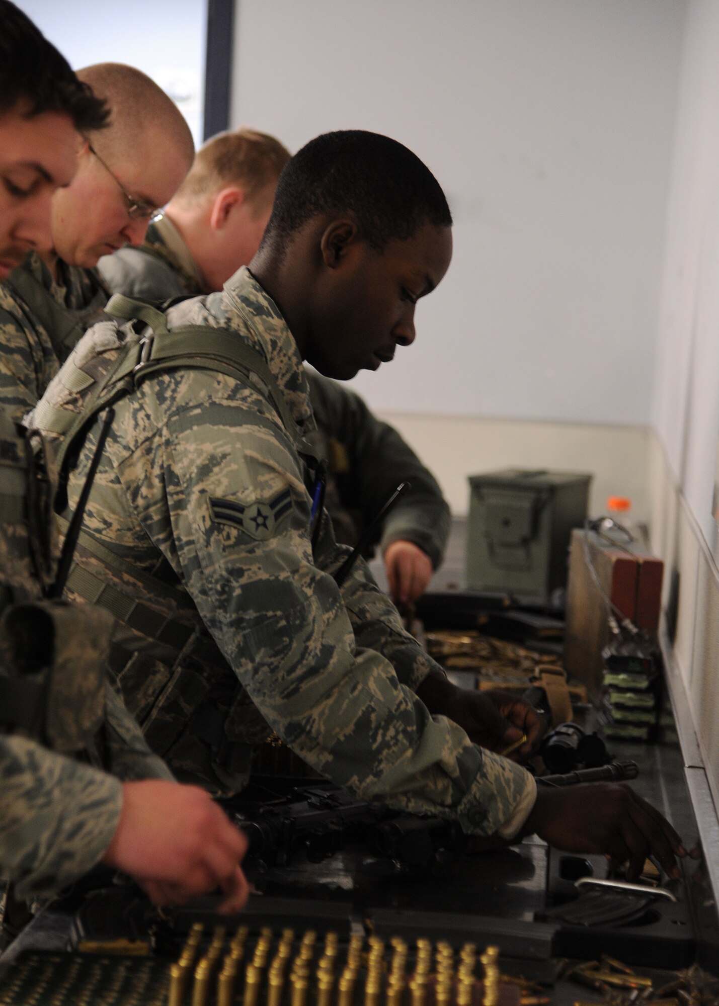 Airman 1st Class Danallen Lee, 341st Security Forces Squadron member, lays out ammunition to load a clip for his M-4 rifle. After he arms up with ammunition and his weapon, Lee attends Guardmount where he’s briefed on the weather, Personnel Reliability Program responsibilities, safety and a chosen career topic. (U.S. Air Force photo/Senior Airman Cortney Paxton) 