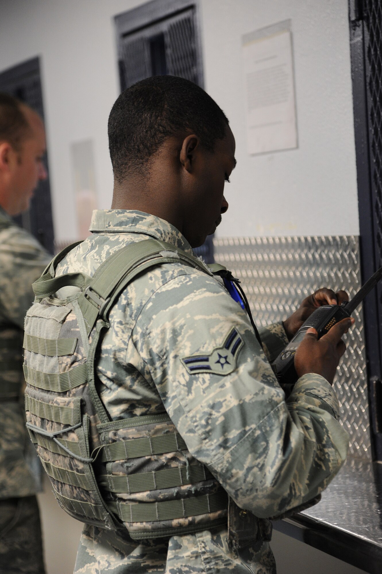 Airman 1st Class Danallen Lee, 341st Security Forces Squadron member, sets his radio after receiving it from the armory staff March 25. After arming up with his weapon, Lee posts out to the weapons storage area for an eight-hour shift. (U.S. Air Force photo/Senior Airman Cortney Paxton) 