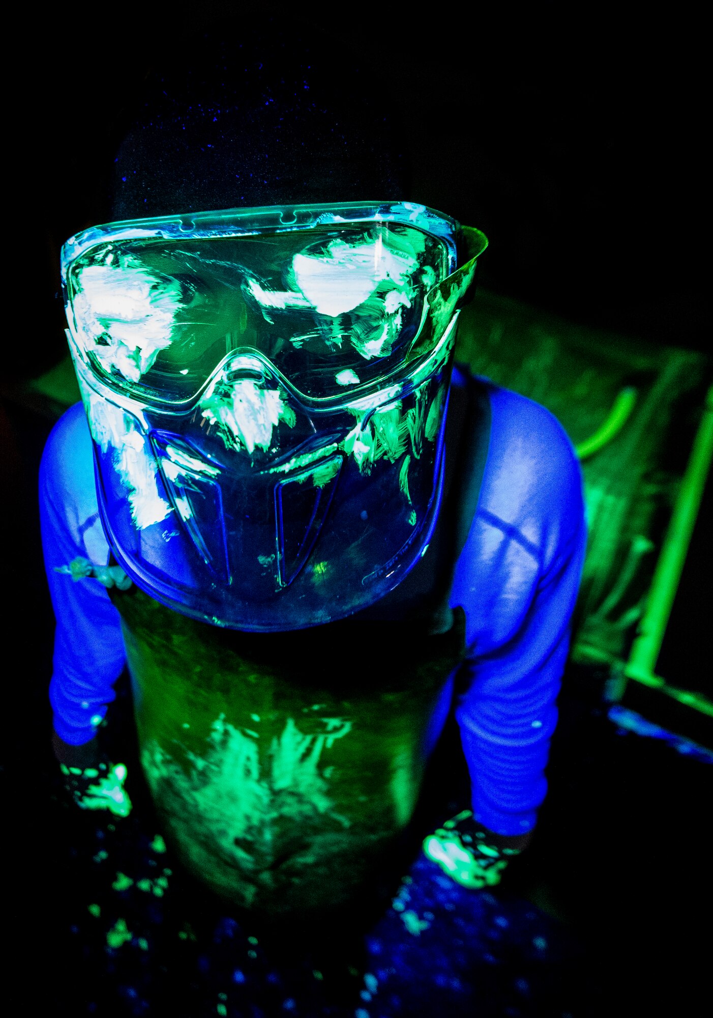 Airman 1st Class Henry Paulk, 437th Maintenance Squadron non-destructive inspector, is required to wear a protective mask, apron and gloves when handling aircraft parts that have been sprayed with a dye to prevent any of the liquid from getting  on his skin or in his eyes, March 8, 2014, at Joint Base Charleston, S.C. The 437th MXS NDI shop inspects metal objects ranging from nuts and bolts, to large hooks and sheets of metal. (U.S. Air Force photo/Senior Airman Dennis Sloan)