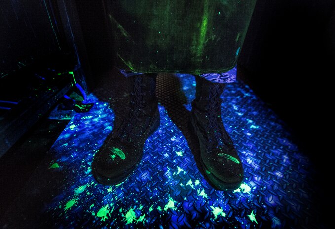 Airman 1st Class Henry Paulk, 437th Maintenance Squadron non-destructive inspector, is required to wear an apron, gloves and protective mask when handling aircraft parts that have been sprayed with a dye March 8, 2014, at Joint Base Charleston, S.C. The 437th MXS NDI shop inspects metal objects ranging from nuts and bolts, to large hooks and sheets of metal. (U.S. Air Force photo/Senior Airman Dennis Sloan)