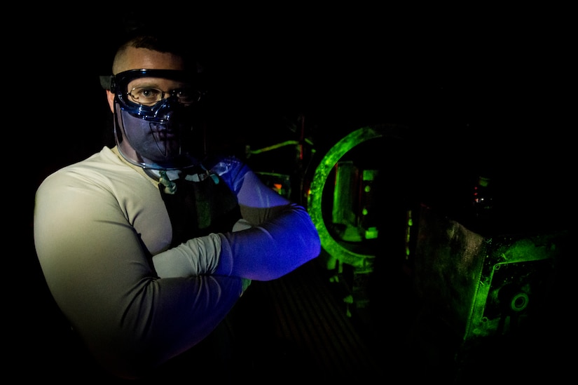 Tech. Sgt. Ryan Michalec, 437th Maintenance Squadron non-destructive inspector, uses ultraviolet lights to inspect aircraft parts without causing any damage to the parts March 8, 2014, at Joint Base Charleston, S.C. The 437th MXS NDI shop inspects metal objects ranging from nuts and bolts, to large hooks and sheets of metal. (U.S. Air Force photo/Senior Airman Dennis Sloan)