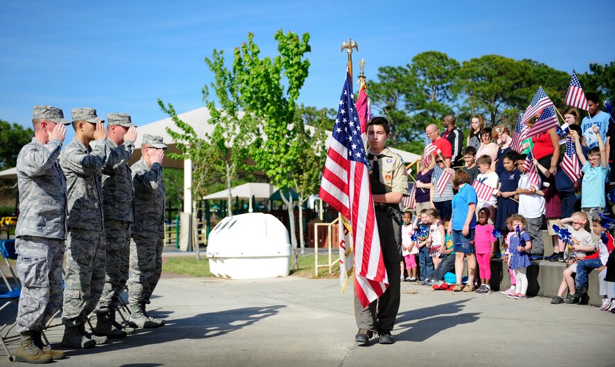 Wing leadership salute the flag as Boy Scouts from Troop 509 post the colors during the proclamation-signing ceremony for month of the military child and child abuse prevention at the community park on Hurlburt Field, Fla., April 2, 2014. The Commando Agencies Reaching Everyone has special events planned throughout April for the Month of the Military Child and Child Abuse Prevention Month on Hurlburt Field. (U.S. Air Force photo/Senior Airman Krystal M. Garrett) 