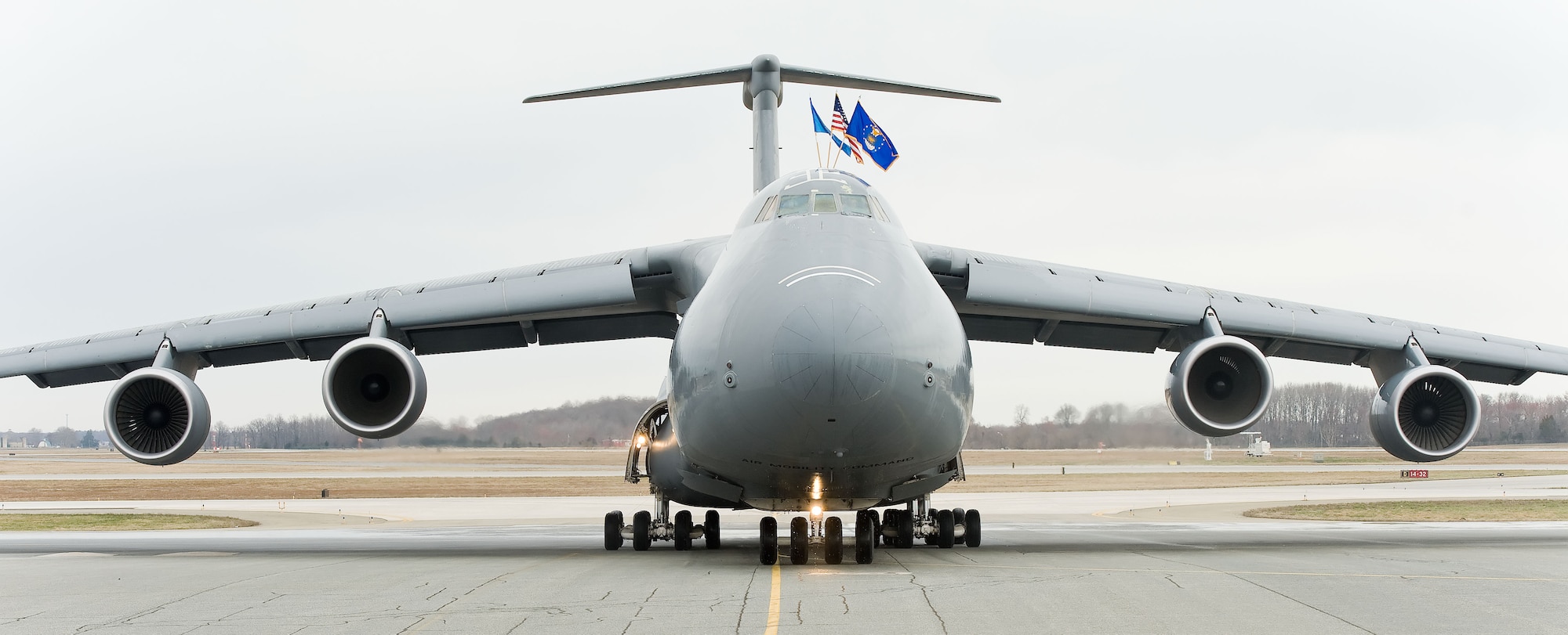 After a customary spray-down by fire trucks, C-5M Super Galaxy 87-0040 taxis onto its parking spot April 2, 2014, at Dover Air Force Base, Del. The delivery of the 18th and final C-5M to Dover AFB completes Team Dover's fleet. (U.S. Air Force photo/Roland Balik)
