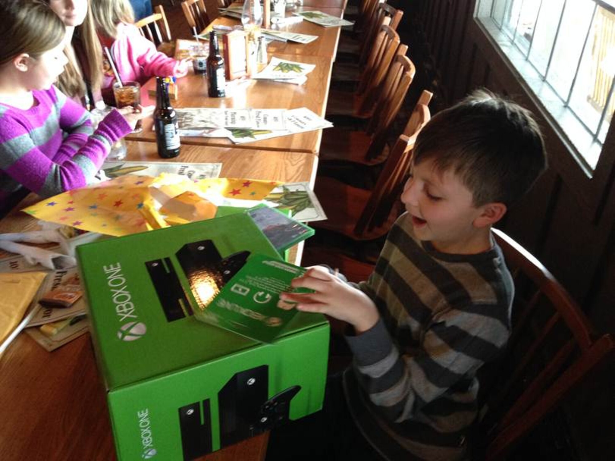 Myles Eckert is suprised to receive an XBox One game console and other gifts from the Wright-Patterson Air Force Base Exchange store March 20. Eckert made national news in February for a kind act toward a soldier. (Photo courtesy of Greg Kehm)