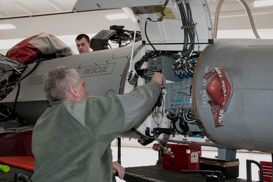 Senior Master Sgt. Dan Manning (front) and Staff Sgt. Erik Johansen (back) conduct avionics upgrades on an F-16 aircraft in the hangar of the 132nd Fighter Wing (132FW), Des Moines, Iowa on Sunday, March 2, 2014.  The 132FW has been selected to assist with this process, called a “Speed Line”, rather than sending the F-16s to Hill Air Force Base as previously done in the past; this saves approximately $100,000.00 per aircraft.  (U.S. Air National Guard photo by Staff Sgt. Linda K. Burger/Released)