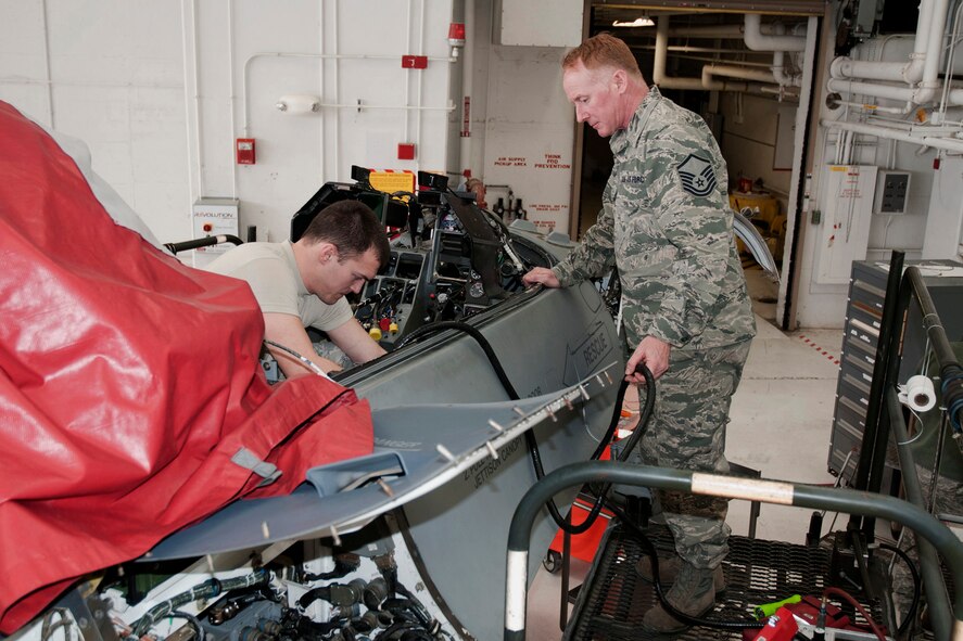 Master Sgt. Eric Kamp (right) and Staff Sgt. Erik Johansen (left) conduct avionics upgrades on an F-16 aircraft in the hangar of the 132nd Fighter Wing (132FW), Des Moines, Iowa on Sunday, March 2, 2014.  The 132FW has been selected to assist with this process, called a “Speed Line”, rather than sending the F-16s to Hill Air Force Base as previously done in the past; this saves approximately $100,000.00 per aircraft.  (U.S. Air National Guard photo by Staff Sgt. Linda K. Burger/Released)