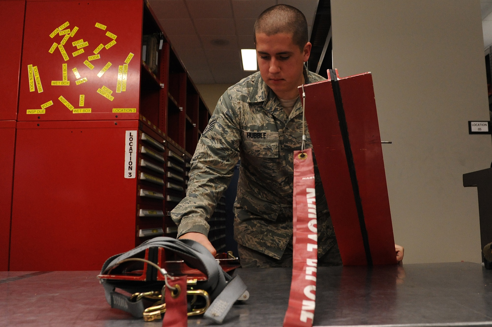 Staff Sgt. Andrew Hubble, a 314th Aircraft Maintenance Squadron consolidated tool kit custodian, picks up elevator locks, March 21, 2014, at Little Rock Air Force Base, Ark.  Hubble has to track, maintain and inspect more than 26,000 pieces of equipment used to work on C-130s at Little Rock AFB. (U.S. Air Force photo by Tech. Sgt. Chad Chisholm)