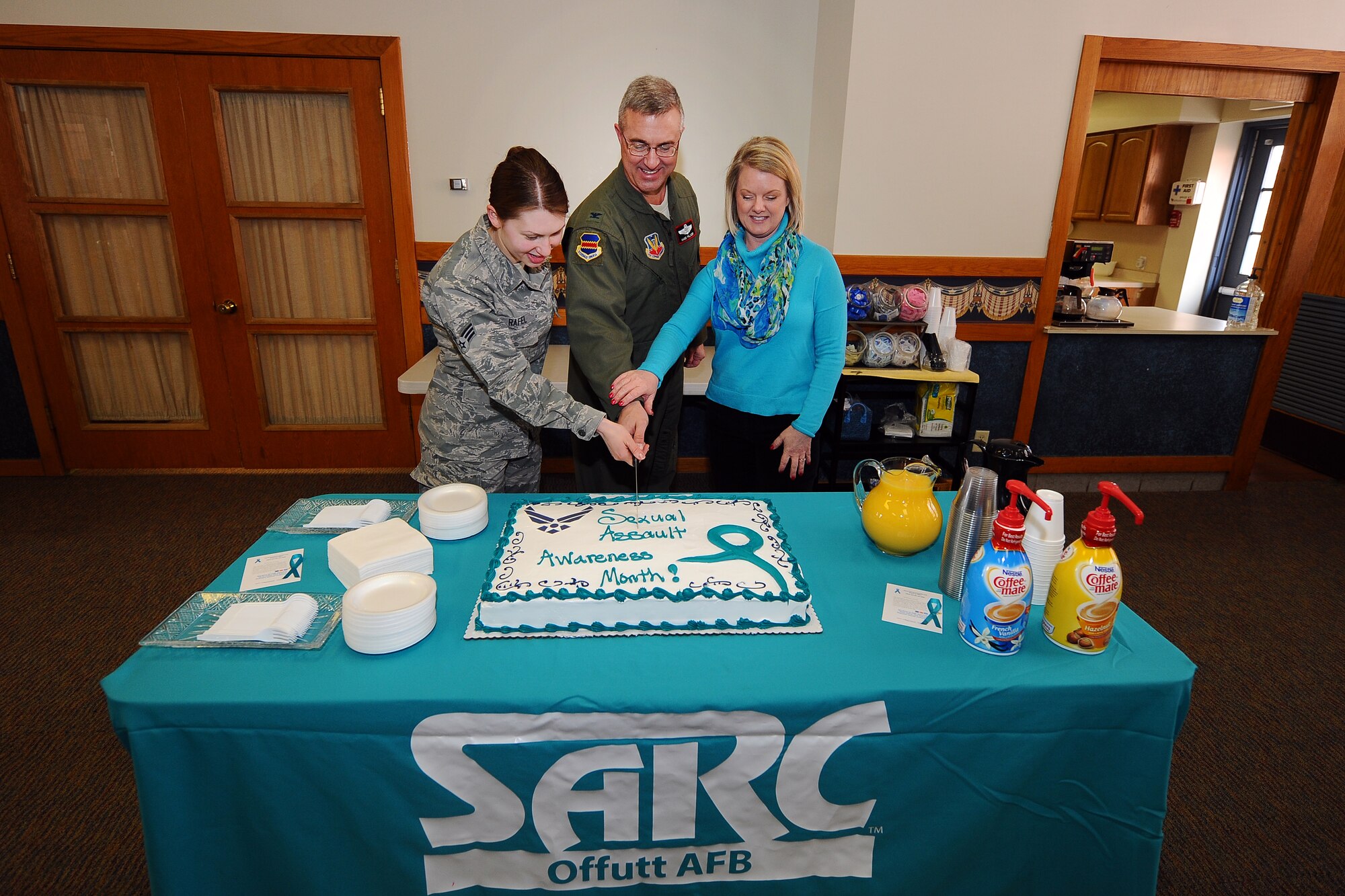 OFFUTT AIR FORCE BASE, Neb. -- U.S. Air Force Senior Airman Jackie Rafel, 55th Logistics Readiness Squadron, U.S Air Force Colonel Hans Palaoro, 55th Wing vice commander, and Jennifer McCabe, Offutt’s Sexual Assault Response Coordinator, ceremoniously cut the cake in honor of Sexual Assault Awareness Month at a ceremony at the SAC Chapel on April 1. April is Sexual Assault Awareness Month throughout the Department of Defense and Team Offutt is using this opportunity to highlight the program and build on existing momentum to fight this crime and ensure everyone is treated with dignity and respect.  (U.S. Air Force photo by Josh Plueger/Released)