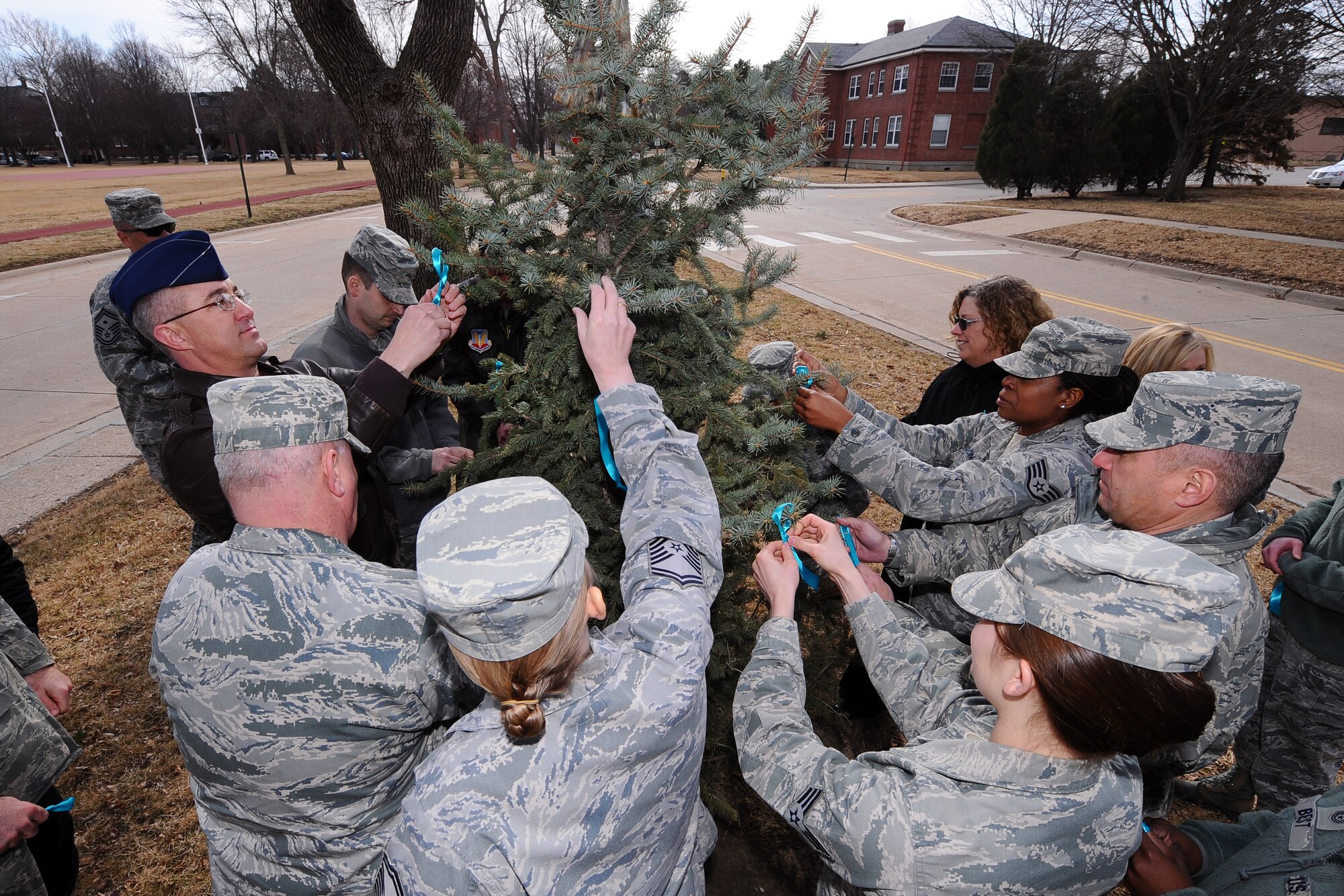 OFFUTT AIR FORCE BASE, Neb. -- A gathering of both Airman and civilians came together here to decorate a tree with teal ribbons in honor of Sexual Assault Awareness Month April 1. The DOD’s theme for Sexual Assault Awareness Month is, “Live Our Values: Step Up to Stop Sexual Assault,” and the Offutt Sexual Assault Prevention and Response team has organized multiple activities throughout the month to highlight this vision.  (U.S. Air Force photo by Josh Plueger/Released)