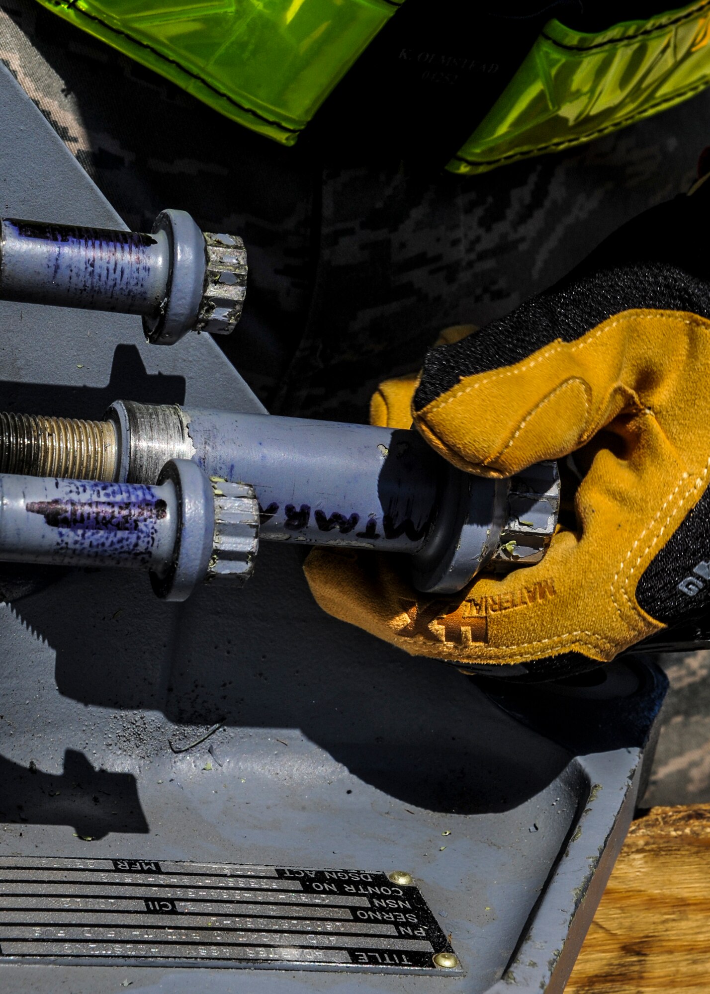 An Airman screws a bolt onto a brace during a unit effectiveness inspection at Moody Air Force Base, Ga., April 2, 2014. A team of Airmen from the 23d Equipment Maintenance Squadron used a ground instructor training aircraft to demonstrate the procedures for recovering a downed plane. (U.S. Air Force photo by Airman 1st Class Alexis Millican/Released)
