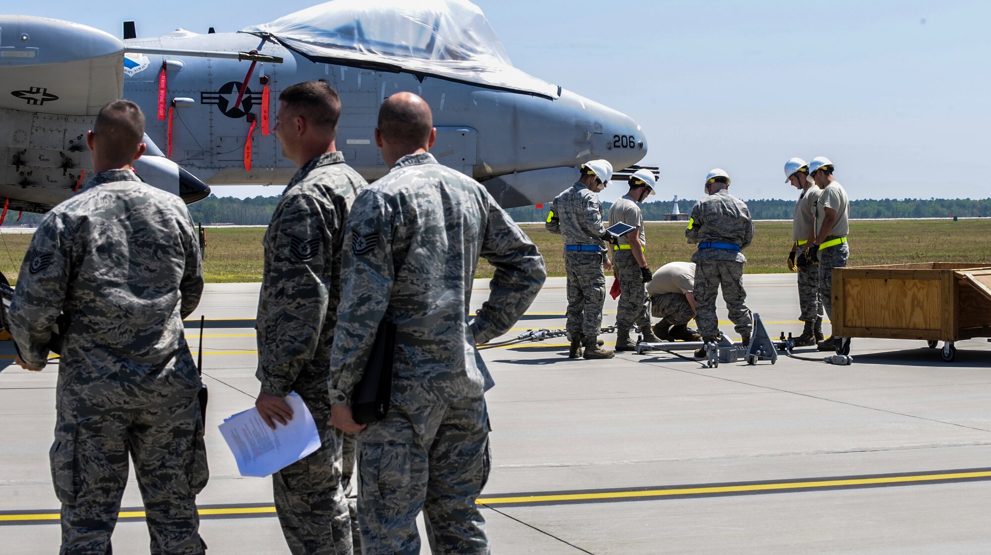 Airmen from the 23d Equipment Maintenance Squadron prepare to attach braces to an A-10C Thunderbolt II during a unit effectiveness inspection at Moody Air Force Base, Ga., April 2, 2014. The A-10 simulated a downed aircraft, giving Airmen a chance to respond accordingly. (U.S. Air Force photo by Airman 1st Class Alexis Millican/Released)