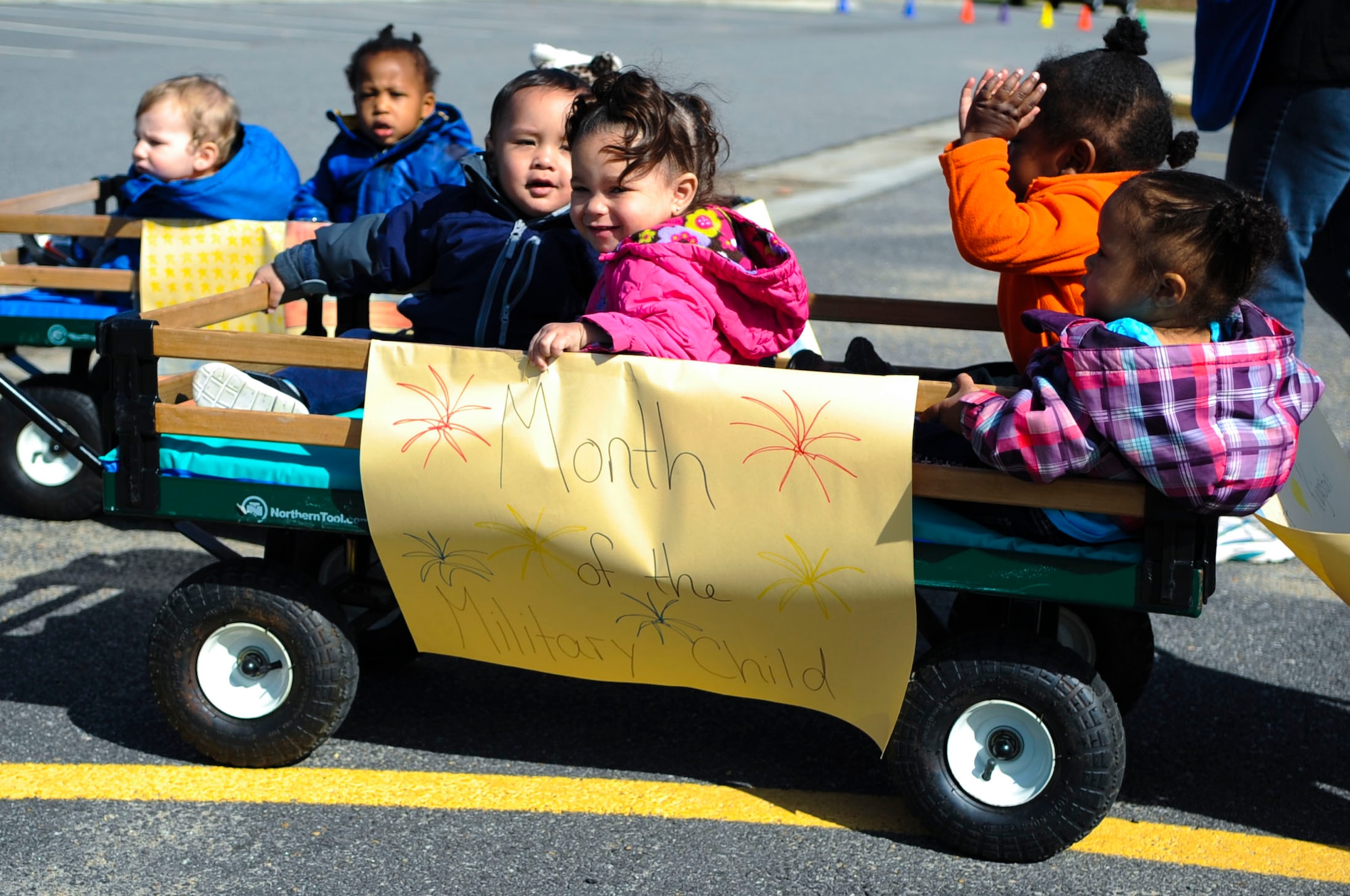 Children attending Pershing Child Development Center ride along in wagons during a Month of the Military Child march at Fort Eustis, Va., April 1, 2014. The Month of the Military Child was established to show the important role children have in the military community, according to Army OneSource. (U.S. Air Force photo by Senior Airman Austin Harvill/Released) 