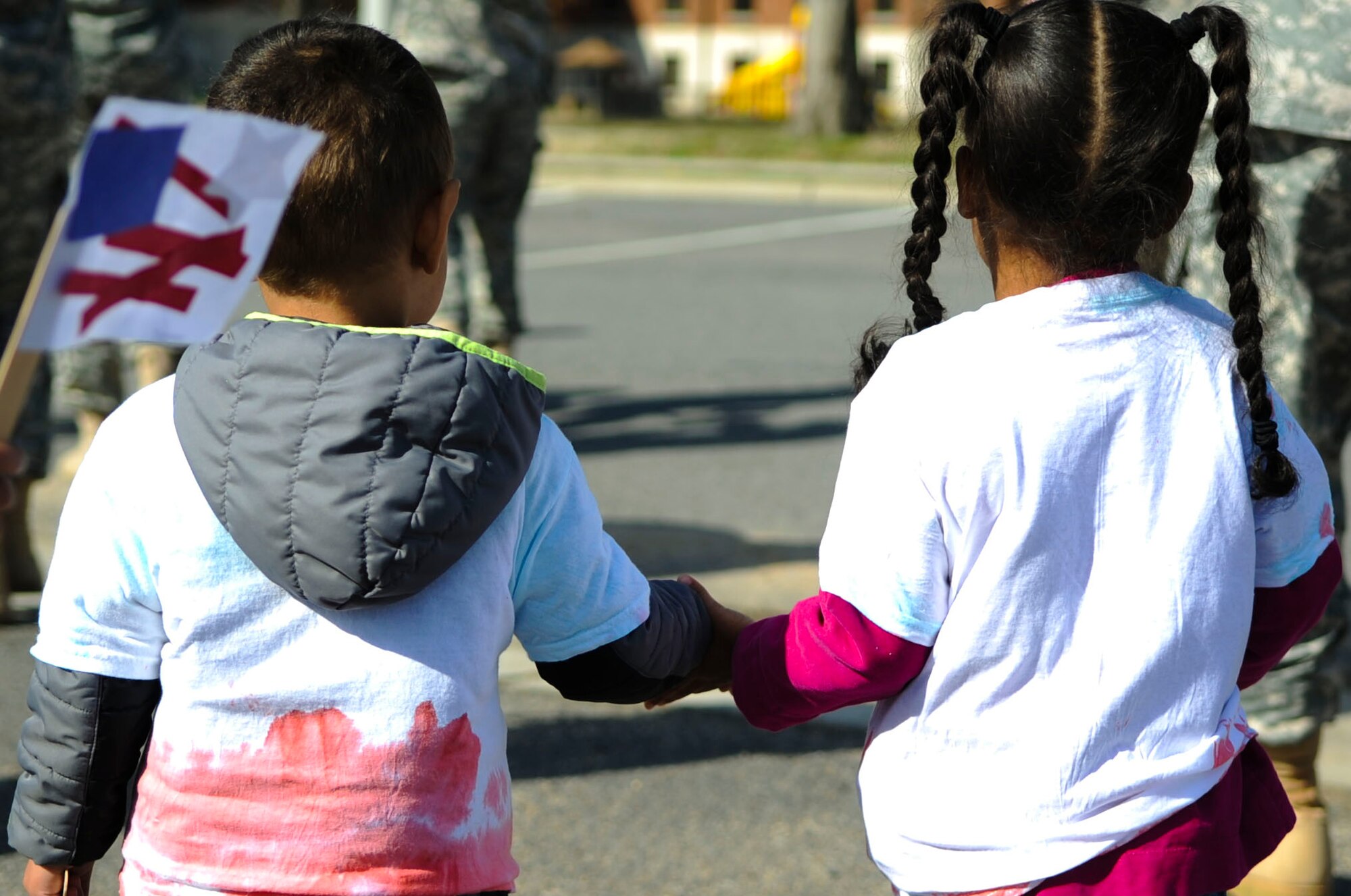 Two children hold hands during a Month of the Military Child march at Fort Eustis, Va., April 1, 2014. The Pershing Child Development Center scheduled more events throughout April to celebrate military children. (U.S. Air Force photo by Senior Airman Austin Harvill/Released) 