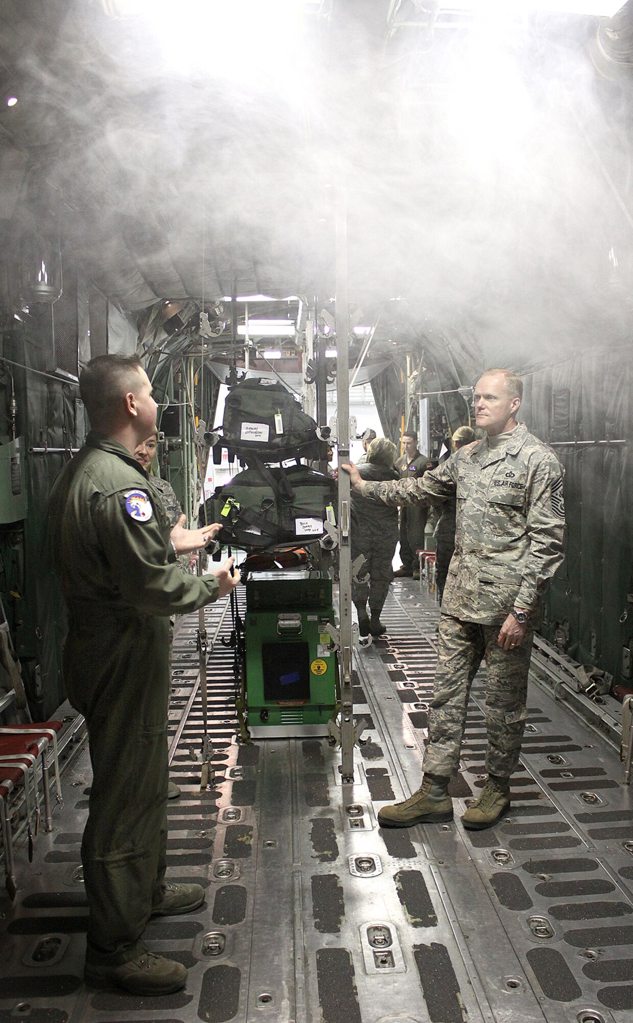 Staff Sgt. Ryan Phillips explains how the simulator can replicate a variety of in-flight emergencies, including the presence of unexplained smoke in the aircraft, to Chief Master Sgt. of the Air Force James Cody during one of his stops at the U.S. Air Force School of Aerospace Medicine March 21. Cody visited the school during his two-day visit to Wright-Patterson Air Force Base. He also spoke to enlisted members in Airman Leadership School and visited the 88 Operations Support Squadron and the 445 Airlift Wing. (Air Force photo by Tara Dixon Engel) 
