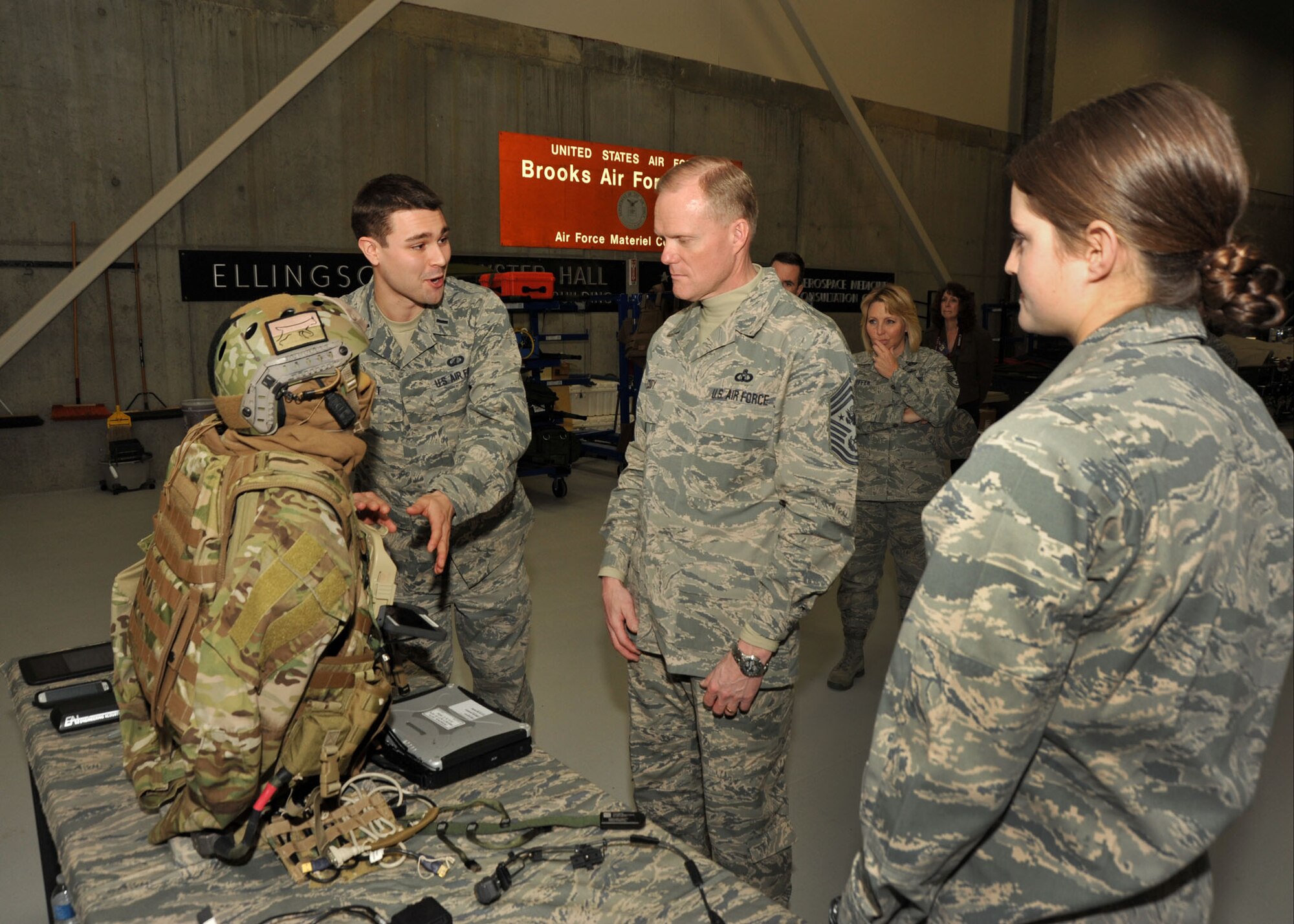 First Lt. Thomas McNitt discusses components of the Battlefield Air Targeting Man-Aided kNowledge (BATMAN) program to Chief Master Sgt. of the Air Force James Cody during one of his tour stops while visiting Wright-Patterson Air Force Base March 21. BATMAN prototypes have outfitted Airmen with equipment from chest-mounted computers, helmet-mounted displays and heated boot insoles. (Air Force photo by Michelle Gigante)