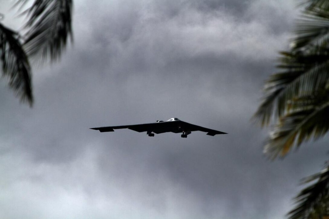 A B-2 Spirit strategic bomber conducts a low approach training flight over Hickam Air Force Base, Hawaii April 2, 2014. Two B-52 Stratofortress strategic bombers from Barksdale Air Force Base, La. and two B-2 Spirit strategic bombers from Whiteman Air Force Base, Mo., flew non-stop from their respective home stations to training ranges within the vicinity of Hawaii and conducted range training operations and low approach training flights at Hickam AFB. (U.S. Marine Corps photographs by Lance Cpl. Wesley Timm // RELEASED)