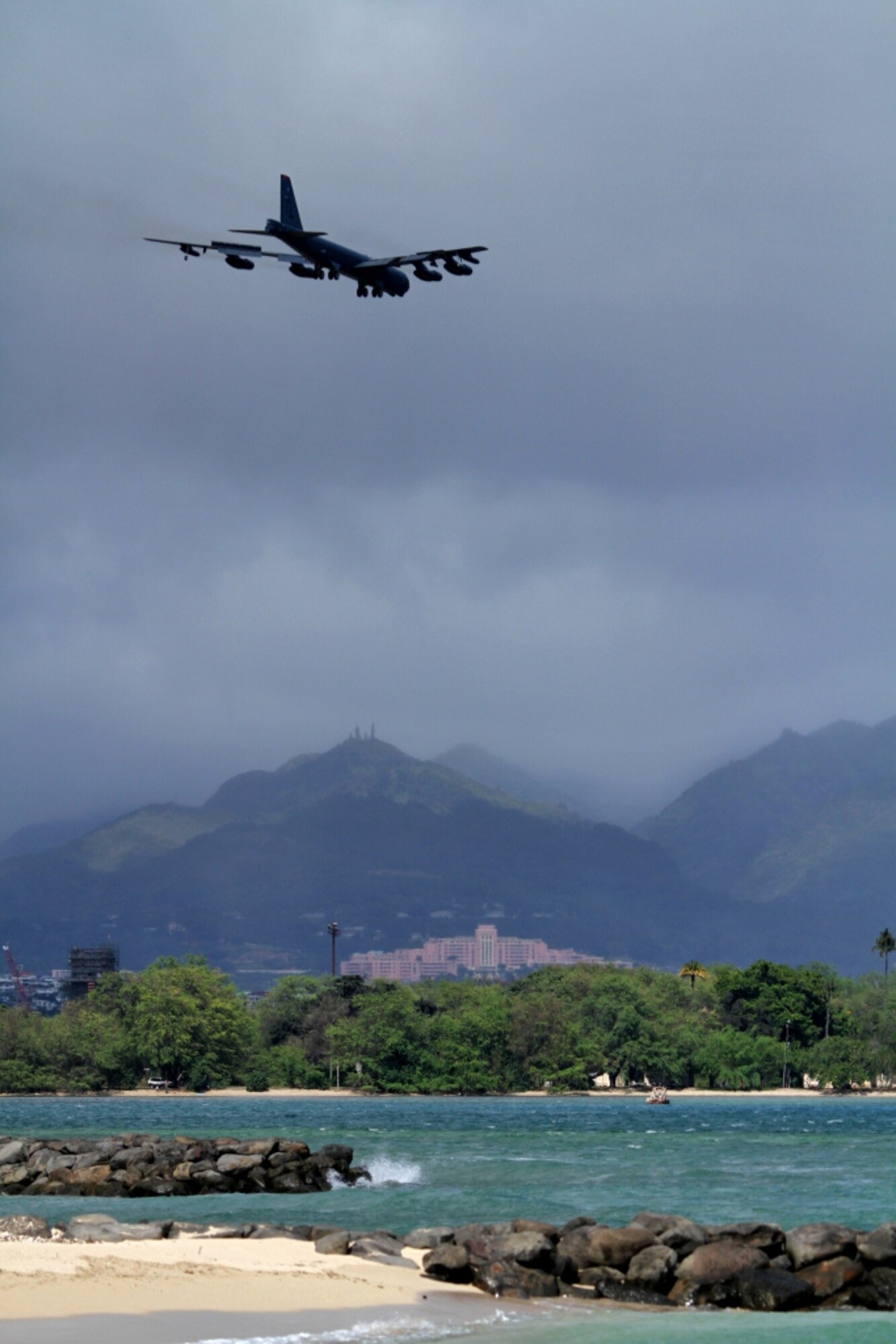 A B-52 Stratofortress strategic bomber conducts a low approach training flight over Hickam Air Force Base, Hawaii April 2, 2014. Two B-52 Stratofortress strategic bombers from Barksdale Air Force Base, La. and two B-2 Spirit strategic bombers from Whiteman Air Force Base, Mo., flew non-stop from their respective home stations to training ranges within the vicinity of Hawaii and conducted range training operations and low approach training flights at Hickam AFB. (U.S. Marine Corps photographs by Staff Sgt. Jason W. Fudge // RELEASED)