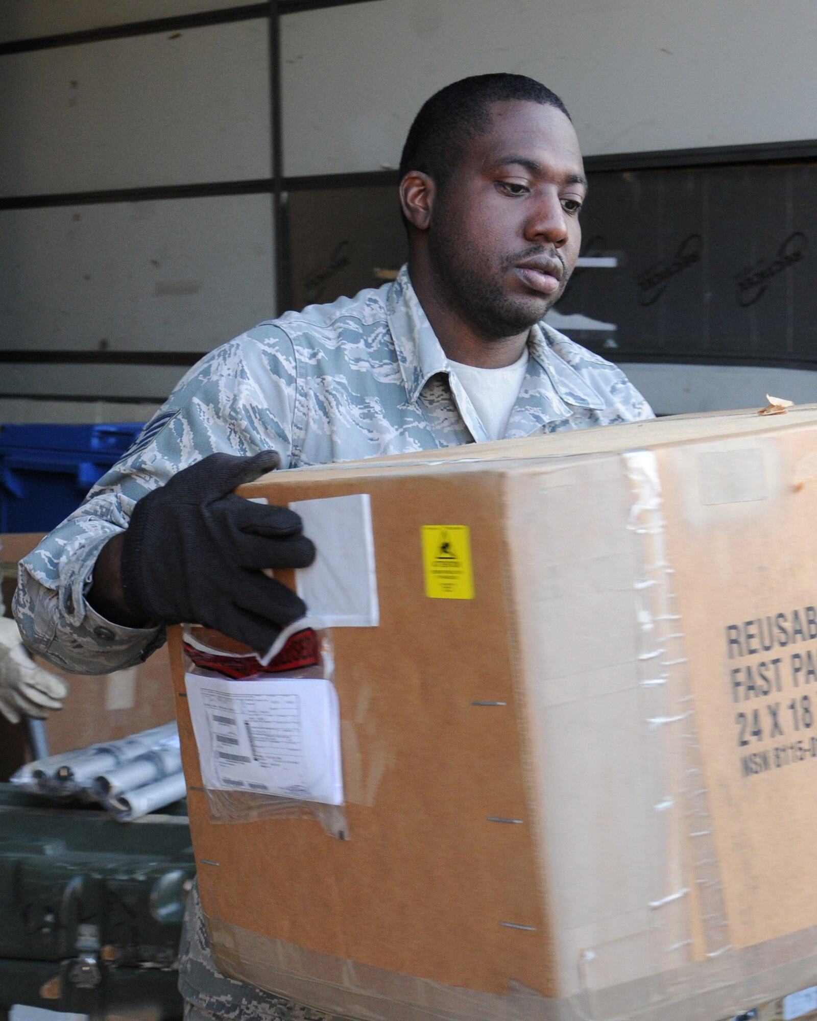 U.S. Air Force Staff Sgt. Kevon McCadney, 100th Logistics Readiness Squadron Aircraft Parts Store supervisor from Detroit, loads boxes containing parts into a vehicle April 1, 2014, on RAF Mildenhall, England. The APS stores approximately 922,000 parts, which it distributes to Team Mildenhall upon request. (U.S. Air Force photo by Gina Randall/Released)