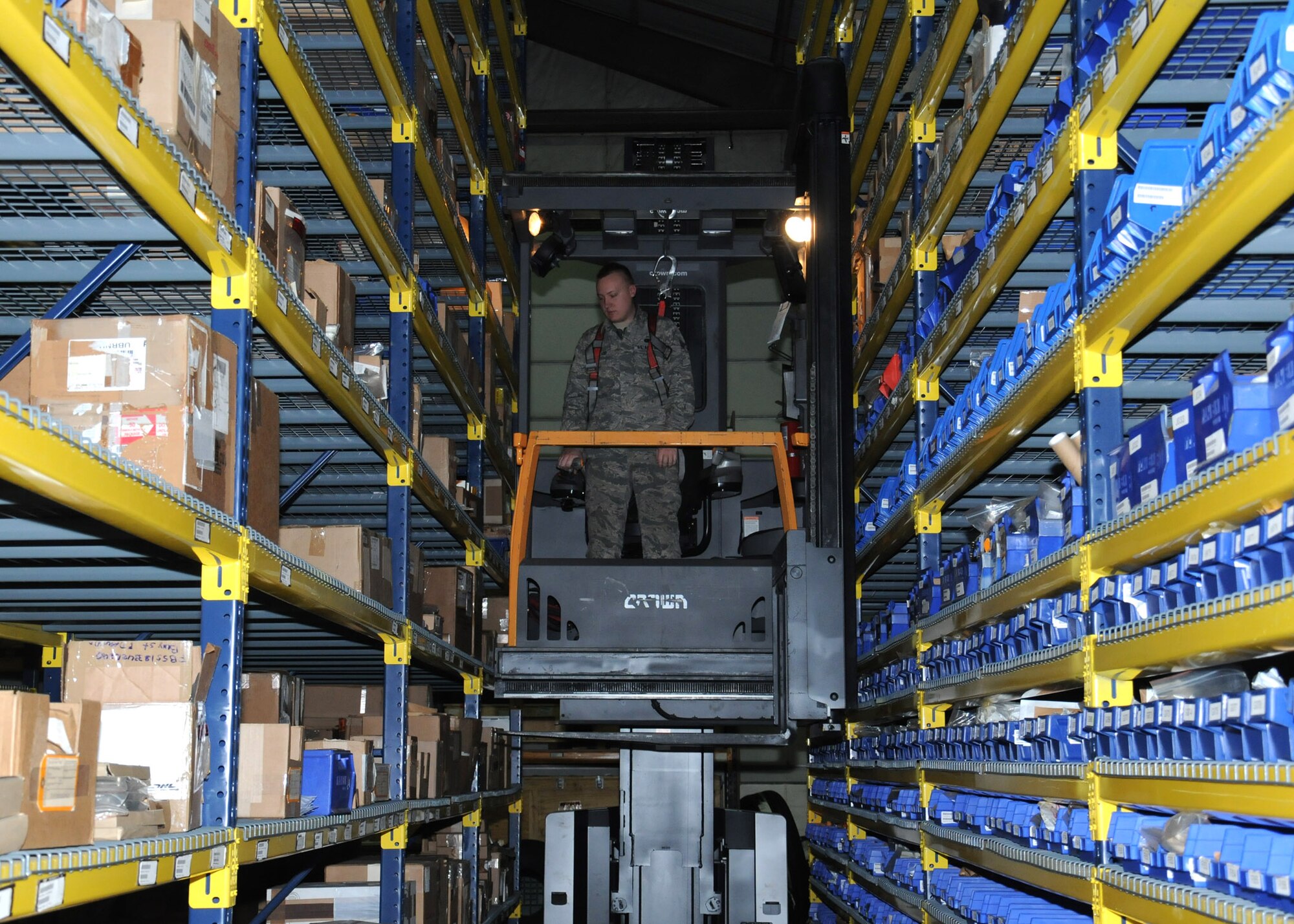 U.S. Air Force Senior Airman Chad Ballard, 100th Logistics Readiness Squadron Aircraft Parts Store journeyman from Camdenton, Miss., uses a forklift to return parts to storage shelves April 1, 2014, on RAF Mildenhall, England. The APS manages approximately 922,000 aircraft parts for Team Mildenhall. (U.S. Air Force photo by Gina Randall/Released)