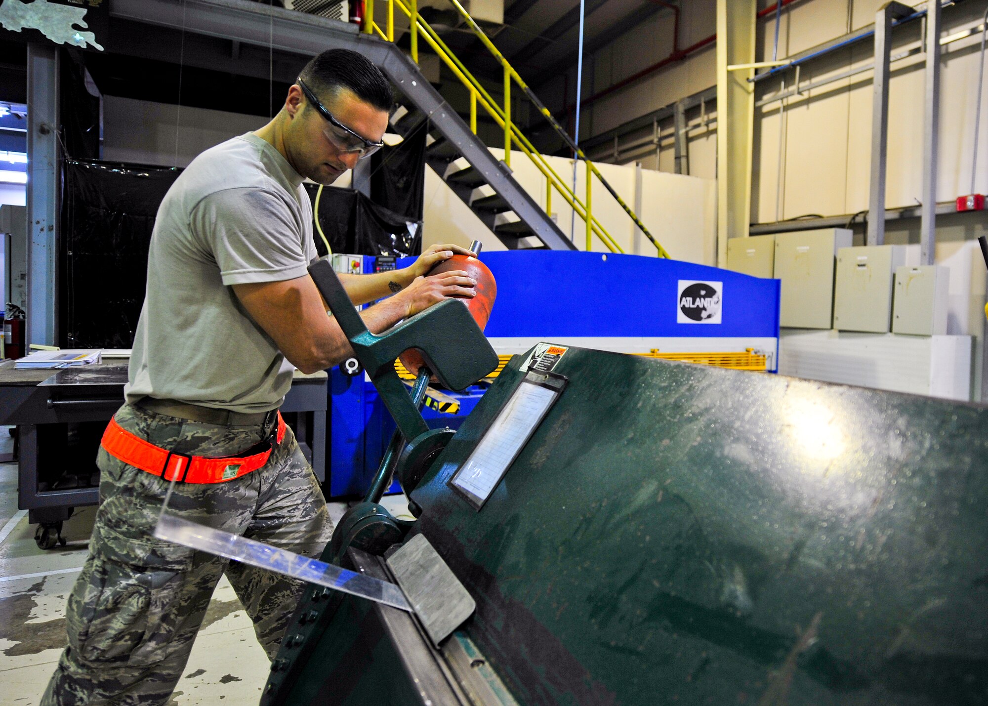 Air Force Senior Airman Cody Borden, 380th Expeditionary Maintenance Squadron Aircraft Structural Maintenance journeyman, uses a cornice brake to fabricate an aircraft part at an undisclosed location in Southwest Asia, April 1, 2014. Structural maintainers use metal working to create replacement parts for aircraft. Borden is a native of Newport News, Va. (U.S. Air Force photo by Staff Sgt. Michael Means/Released)
