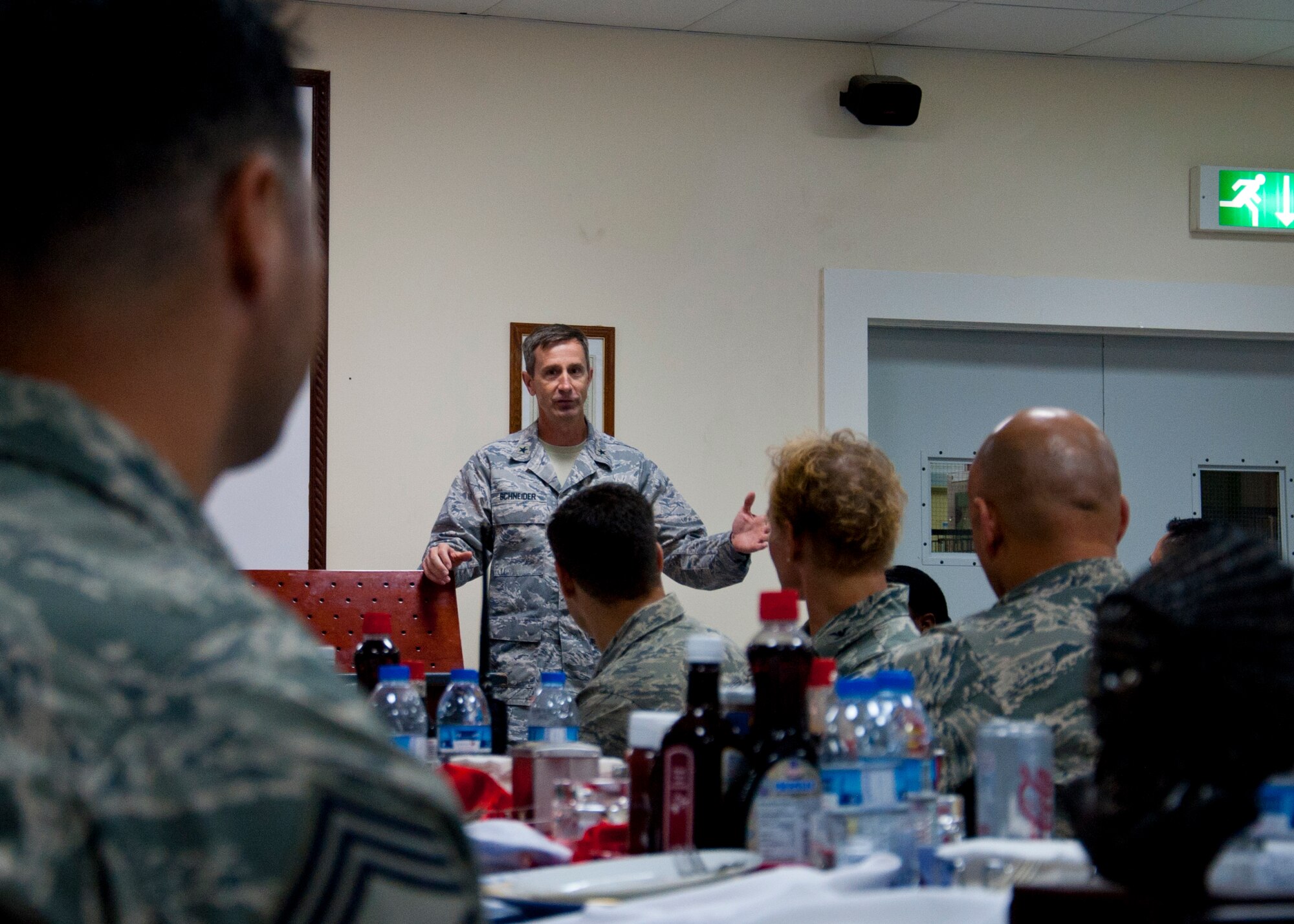 Brig. Gen. Kevin Scheider, 380th Air Expeditionary Wing commander, speaks during the Chief's Induction Ceremony at an undisclosed location in Southwest Asia, March 29, 2014. (U.S. Air Force photo by Staff Sgt. Michael Means/Released)
