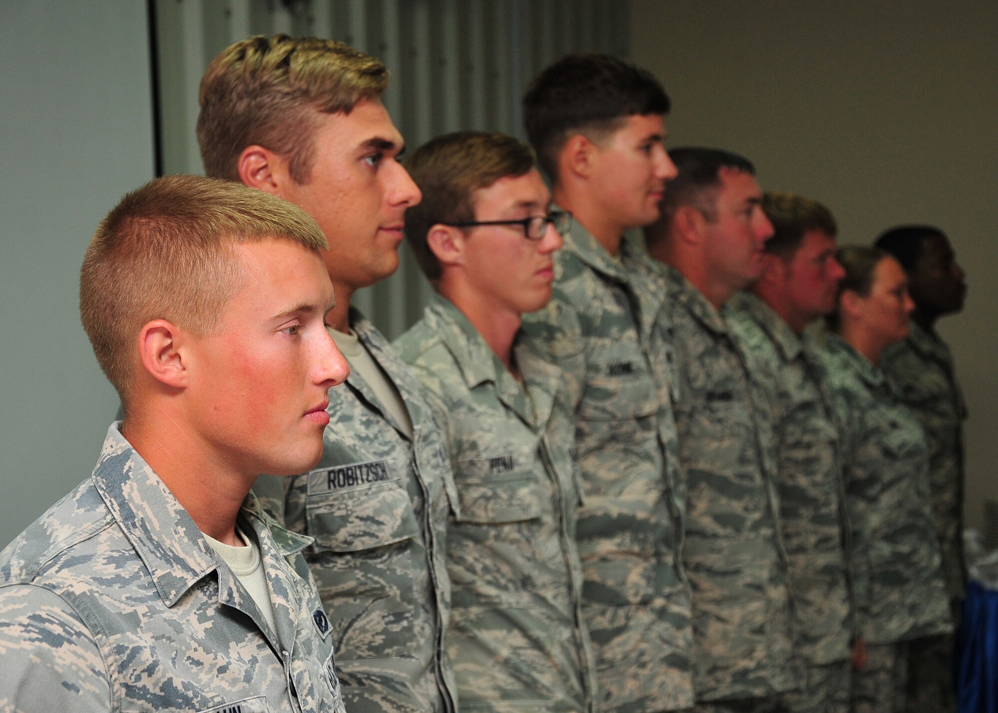 Airmen line up to represent each rank within the enlisted force structure and perform candle lighting ceremony at an undisclosed location in Southwest Asia, March 31, 2014. (U.S. Air Force photo by Staff Sgt. Michael Means/Released)
