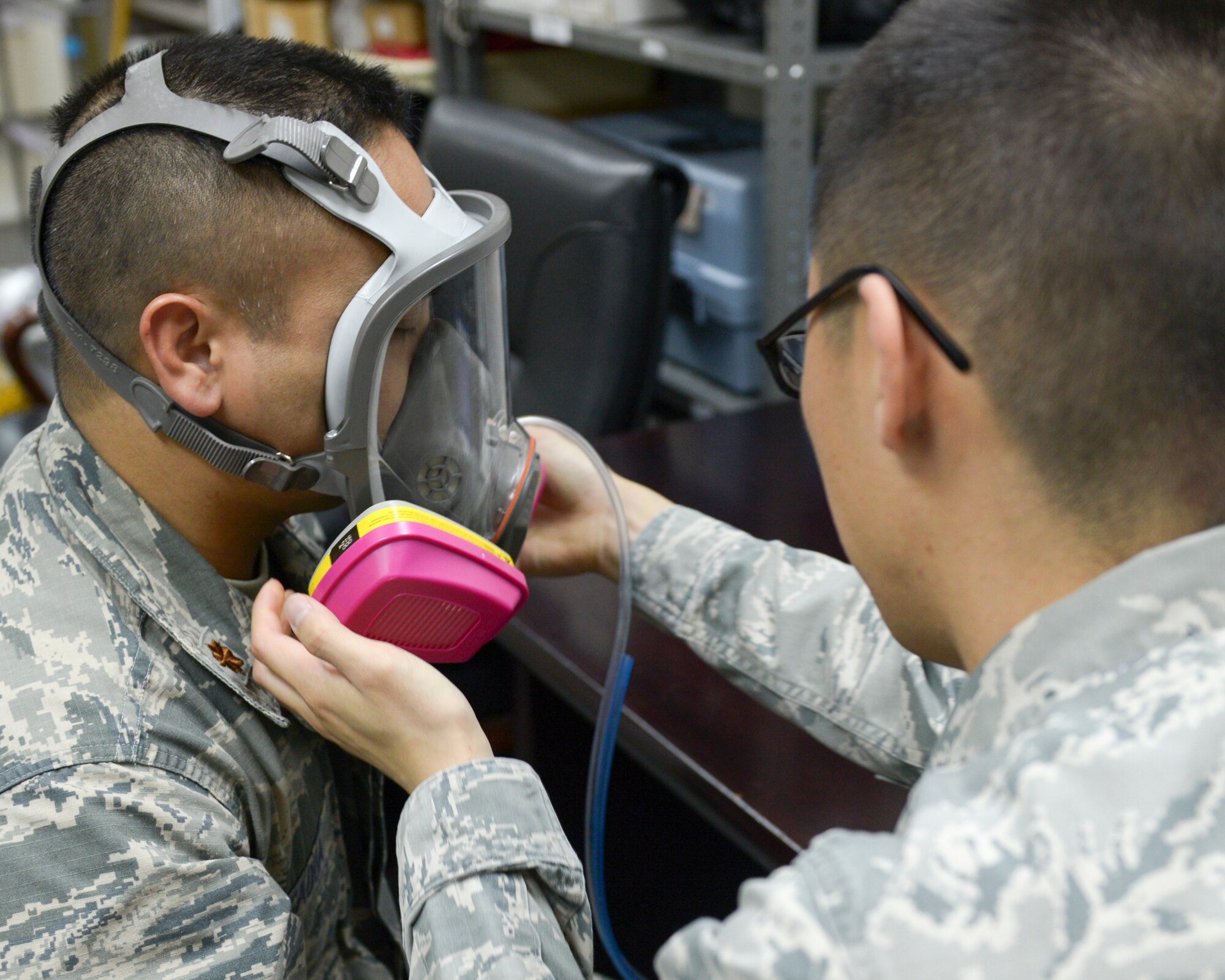 Airman 1st Class Julian Kim, 374th Aerospace Medicine Squadron bioenvironmental engineering technician, performs a respiratory fit test using a respirator fit tester at Yokota Air Base, Japan, April 1, 2014. The machine ensures the mask properly fits and protects of industrial workers. (U.S. Air Force photo by Airman 1st Class David Danford/Released) 