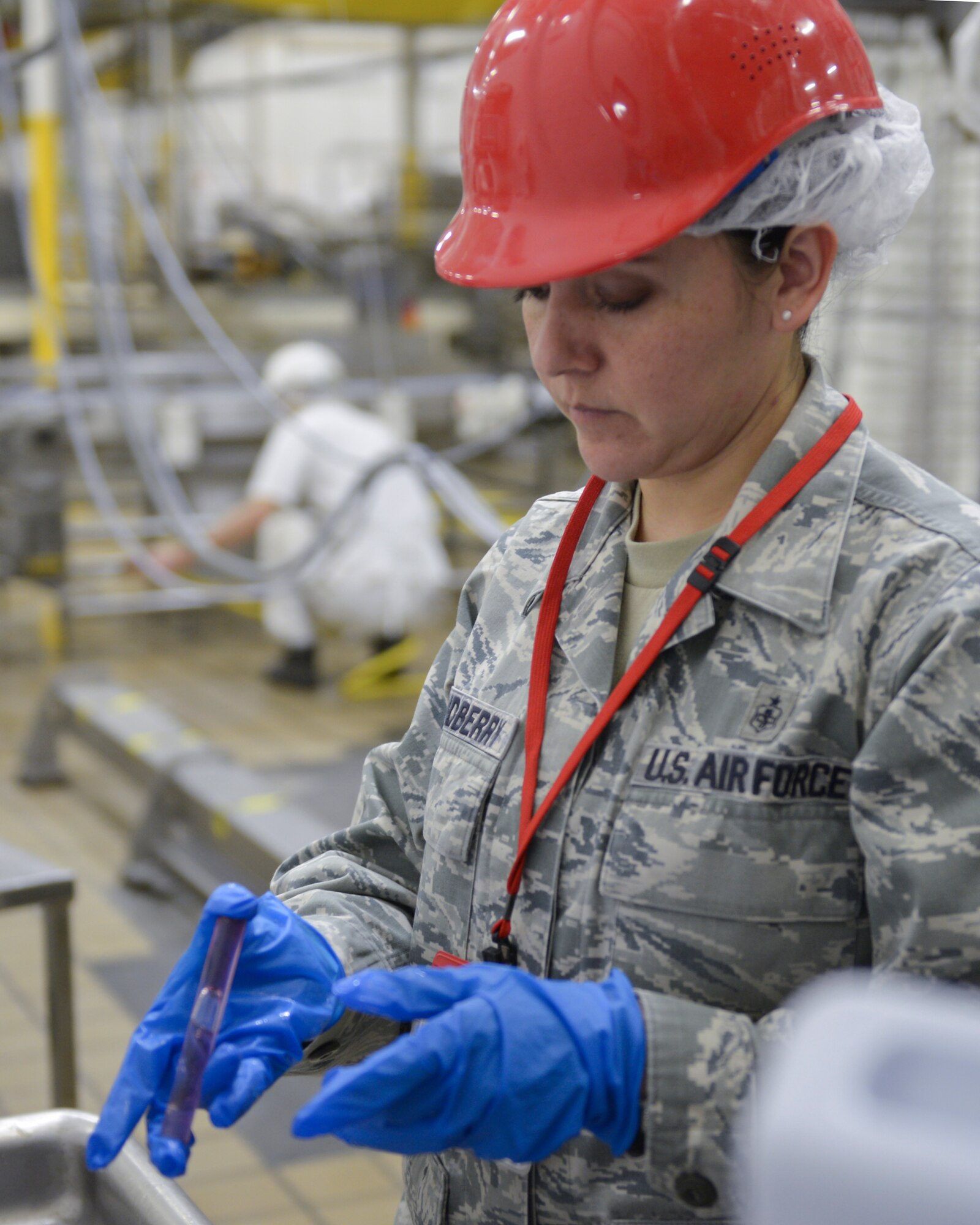 Tech. Sgt. Norma Grandberry, 374th Medical Group noncommissioned officer in charge of education and training, examines a water sample at Yokota Air Base, Japan, April 1, 2014. Regular tests are made to ensure the integrity of Yokota’s water supply. (U.S. Air Force photo by Airman 1st Class David Danford/Released)
