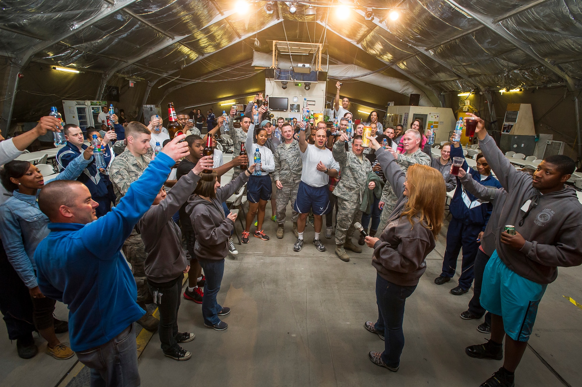 Airmen make a toast to Pete's Place before its closure at Transit Center at Manas, Kyrgyzstan, March 31, 2014. Pete's Place was a centralized recreation center for transients and permanent party members to socialize and build morale. Pete’s Place was named after Peter J. Ganci Jr., a New York City fire chief who lost his life on Sept. 11, 2001. (U.S. Air Force photo illustration/Senior Airman George Goslin)(Part of this image was altered for security)
