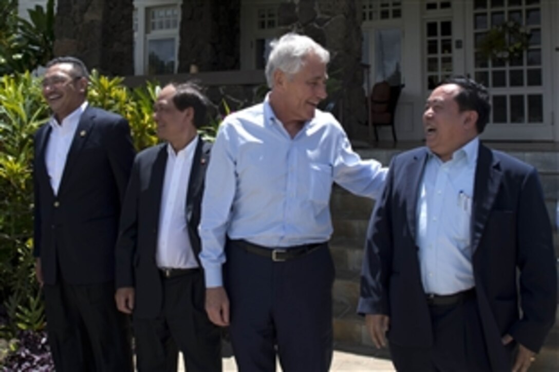U.S. Defense Secretary Chuck Hagel laughs with several defense ministers from the Association of Southeast Asian Nations in Honolulu, April 2, 2014. Hagel is hosting the ASEAN forum to help develop defense relations in the region.