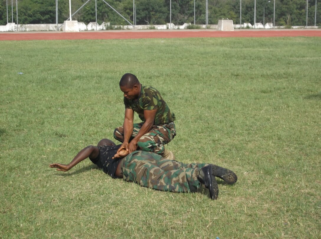 Nigerian soldiers practice take down techniques taught to them by Marines with Special-Purpose Marine Air-Ground Task Force Africa 14.1 during a training exercise, March 19. The group of four Marines trained approximately 20 Nigerian soldiers on basic non-lethal weapons techniques in support of U.S. Africa Command and Marine Corps Forces Europe and Africa’s theater security cooperation requirements.