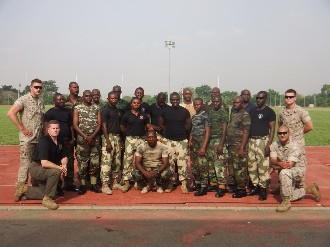Marines with Special-Purpose Marine Air-Ground Task Force Africa 14.1 and Nigerian soldiers, pose for a photo in Abuja, Nigeria, March 19. The group of four Marines trained approximately 20 Nigerian soldiers on basic non-lethal weapons techniques in support of U.S. Africa Command and Marine Corps Forces Europe and Africa’s theater security cooperation requirements.