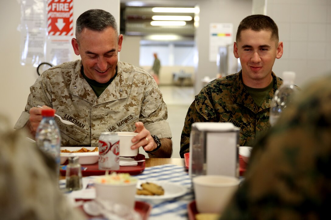 Brigadier Gen. James Lukeman, commanding general of 2nd Marine Division, eats lunch with Lance Cpl. Cody Turner, a mortarman, along with other Marines of 3rd Battalion, 8th Marine Regiment, 2nd Marine Division assigned to Black Sea Rotational Force 14 during his visit to Mihail Kogalniceanu Air Base, Romania, April 3, 2014. Black Sea Rotational Force 14 is a contingent of Marines and sailors tasked with maintaining positive relations with partner nations, regional stability and increasing interoperability while providing the capability for contingency response, as directed by U.S. European Command, in the Black Sea, Balkan and Caucasus regions of Eastern Europe. (Official Marine Corps photo by Lance Cpl. Scott W. Whiting, BSRF PAO/ Released) 