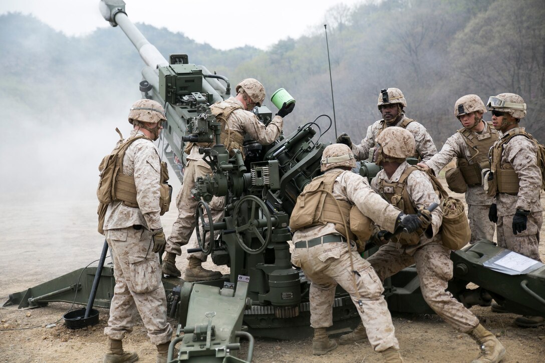Artillery Marines fire off rounds from M777A2 lightweight 155 mm howitzers April 3 at Su Seung-ri Range in the Republic of Korea as part of Exercise Ssang Yong 2014. The Marines shot off a total of 40 rounds between four weapons in less than five minutes. Ssang Yong is an exercise that showcases the amphibious and expeditionary capabilities of the ROK and U.S. forces as well as the maturity of the relationship between the two nations. The Marines are with Golf Battery, 2nd Battalion, 11th Marine Regiment currently assigned to Battalion Landing Team 2nd Bn., 5th Marines, 31st Marine Expeditionary Unit, III Marine Expeditionary Force. (U.S. Marine Corps photo by Cpl. Lena Wakayama/Released)