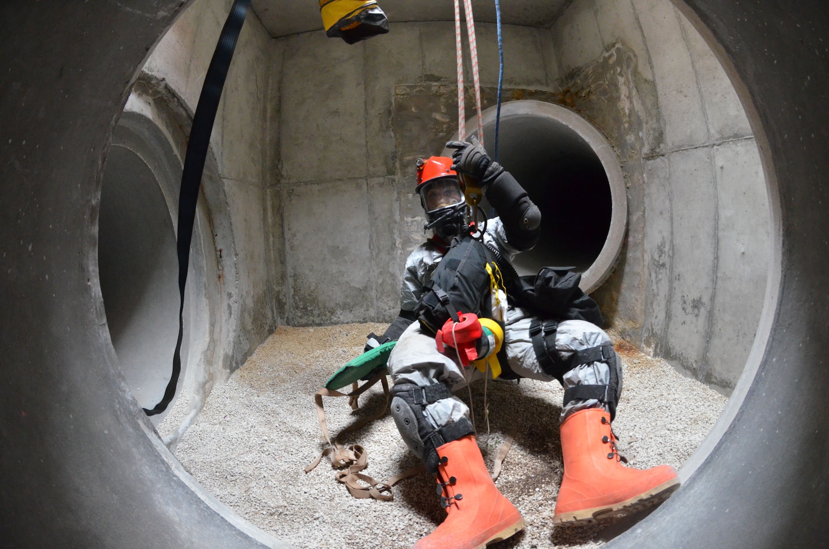 Tech. Sgt. Danreb Faustino from the Florida Air National Guard's 125th Medical Group is hoisted from a tunnel as part of a simulated collapsed building during a FL-CERFP External Evaluation at Camp Blanding Joint Training Center, Fla., March 27, 2014. 