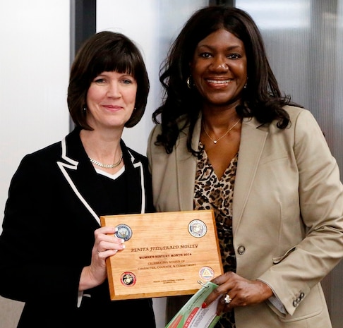 Benita Fitzgerald Mosley (right) accepts a plaque from Deputy Commander for Resource Management Michelle Cresswell-Atkinson after speaking April 1 at a Marine Corps Systems Command Women's History Month presentation. Fitzgerald Mosley was the first African-American woman and just the second American woman to win Olympic gold in the 100-meter hurdles at the 1984 Olympic Games. She now serves as chief of organizational excellence for the U.S. Olympic Committee. 