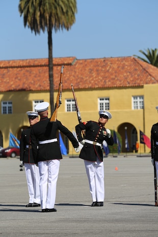 Members of the Silent Drill Platoon mirror each other’s drill movements, including a rifle toss, during the rifle inspection portion of the Battle Color Ceremony on Shepherd’s Field aboard the depot, March 15. The 24-man platoon delivered a high precision drill routine with their M1 Garand rifles with fixed bayonets in complete silence.