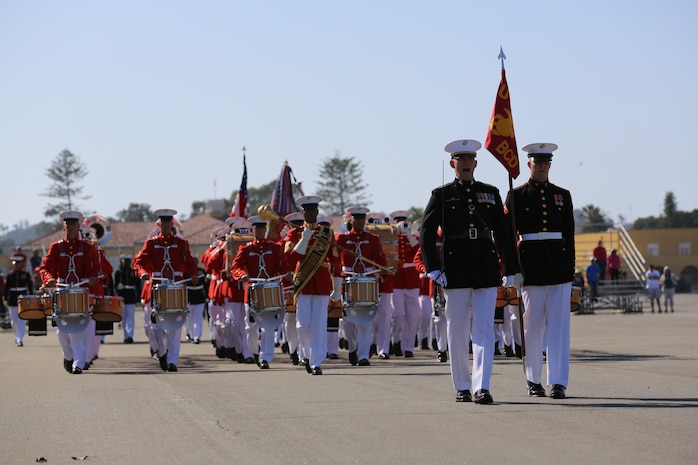 The Battle Color Detachment marches by the parade reviewing officer during the Pass in Review portion to conclude the Battle Color Ceremony on Shepherd's Field aboard the depot, March 15. The detachment features the U.S. Marine Drum & Bugle Corps, the Silent Drill Platoon, and the Marine Corps Color Guard.