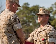 Brigadier General Edward D. Banta (left), the commanding general of the 2nd Marine Logistics Group, shakes the hand of Staff Sgt. Brandon R. Trent, a Lawrence, Kan., native and explosive ordnance disposal technician with 2nd EOD Company, 8th Engineer Support Battalion, 2nd MLG, during a Bronze Star Medal award ceremony aboard Camp Lejeune, N.C., April 4, 2014. Trent earned the medal with combat distinguishing device for his actions disarming improvised explosive devices while deployed in support of Operation Enduring Freedom in 2013. In a period of less than 24 hours, Trent rendered nine improvised explosive devices safe during a clearing operation in Helmand province, Afghanistan. Trent worked into the night, uncovering and disarming additional IEDs along the way. He manually approached and disarmed two of the IEDs after exhausting remote deactivation methods. (U.S. Marine Corps photo by Cpl. Shawn Valosin)