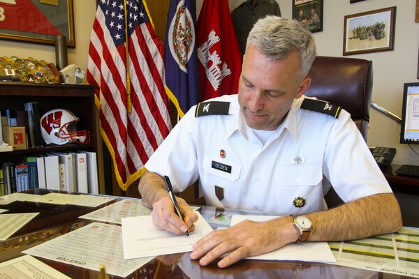 Col. Paul Olsen, Norfolk District commander, signs the environmental permit authorizing Henry County, Va., to develop two facilities at the Commonwealth Crossing Business Center. The project required a federal permit under Section 404 of the Clean Water Act. The permit allows the county to provide infrastructure, transportation and pad site improvements and authorizes mitigation of the impacts to wetlands and streams in the area.