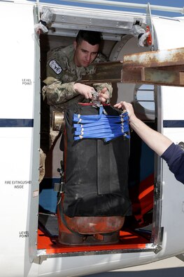 Staff Sgt. Martin Ruemenapp loads a dummy March 10, 2014, as part of a U.S. Air Force Test Pilot School Test Management Project at Edwards Air Force Base, Calif. The project involved modifying a C-12C in order to come up with a more cost-effective way of conducting dummy drop parachute testing for the Air Force. Ruemenapp is a 412th Operations Support Squadron Survival, Evasion, Resistance and Escape instructor. (U.S. Air Force photo/Christian Turner)