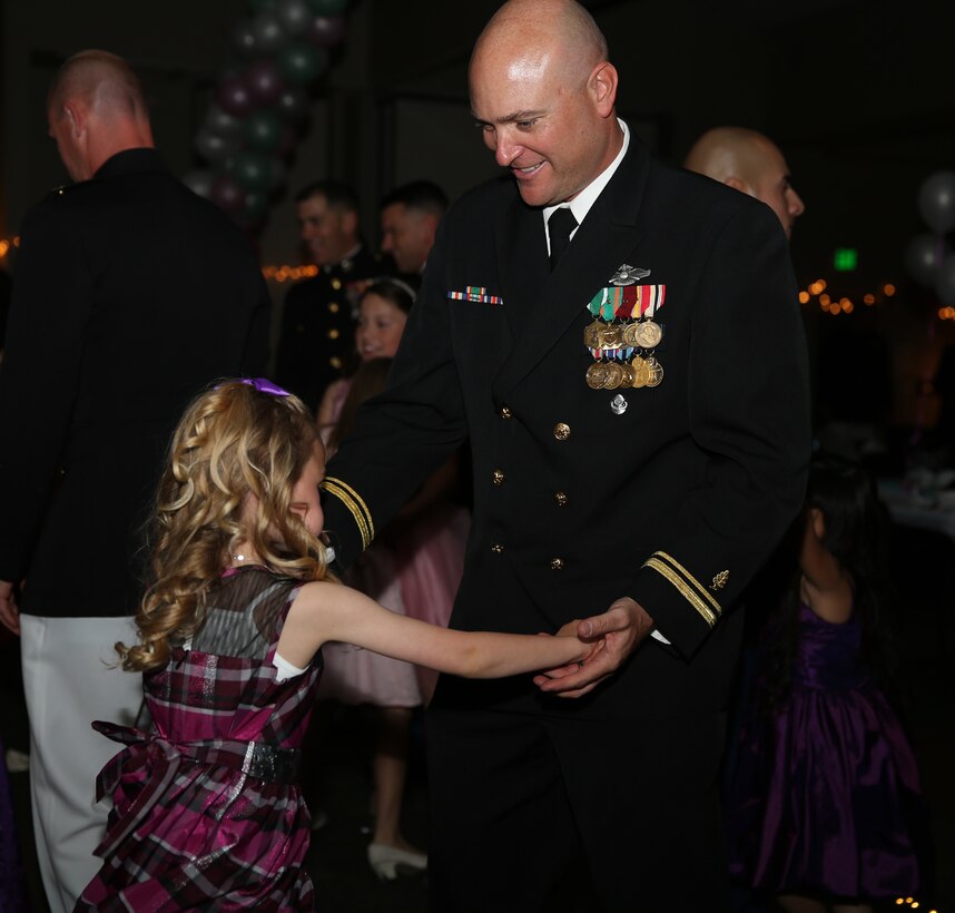 Lt. j. g. Ian Crow, medical officer, 3rd Battalion, 7th Marine Regiment, dances with his daughter, Jocelyn, 5, during the Father-Daughter Dance at Building 1707, March 28.  The dance was held for a second time following its success among Combat Center families last year.